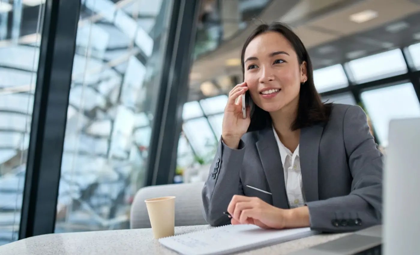 Business woman talking on the phone at a desk