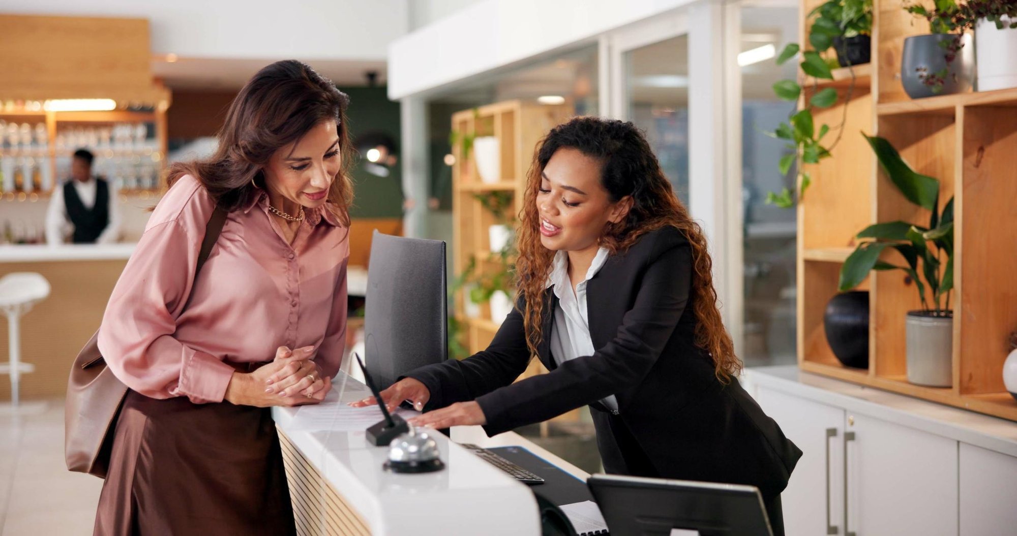 Lady at a front desk helping out a customer