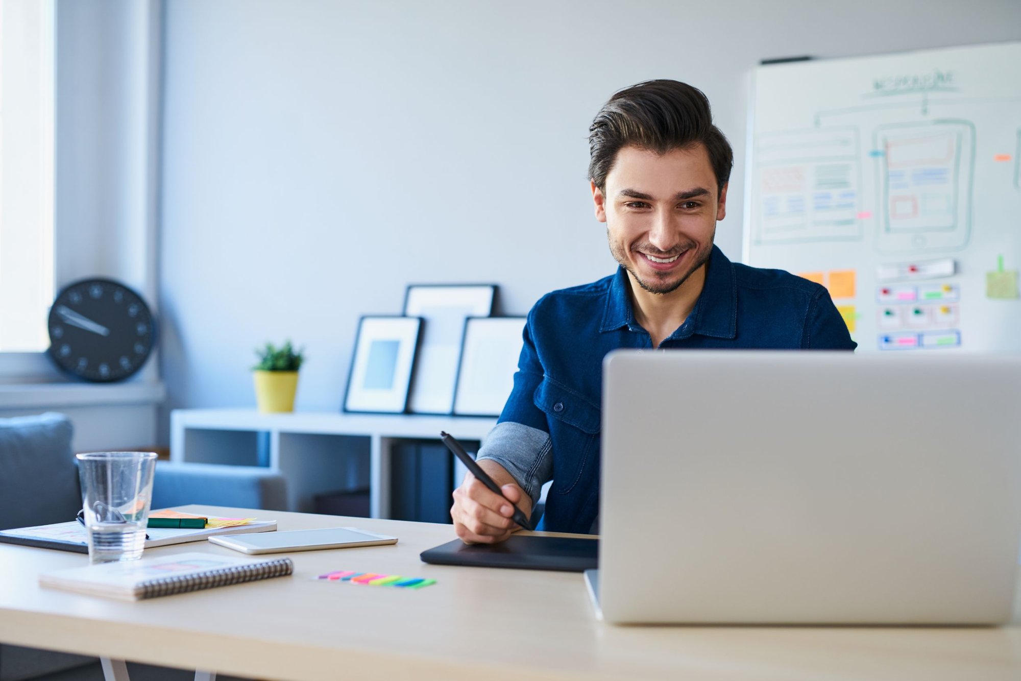 Business man working on computer at a desk in an office