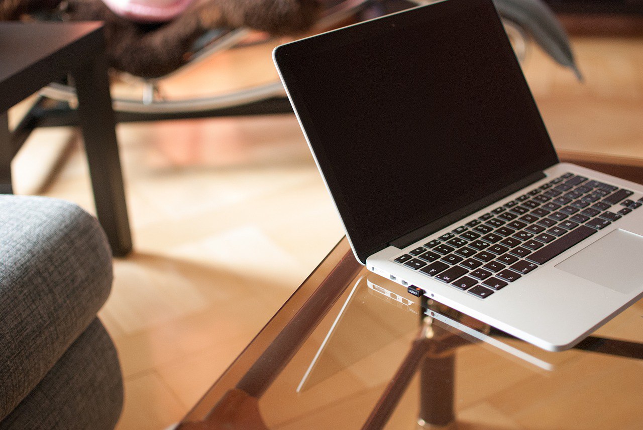 Opened Macbook on a glass table 