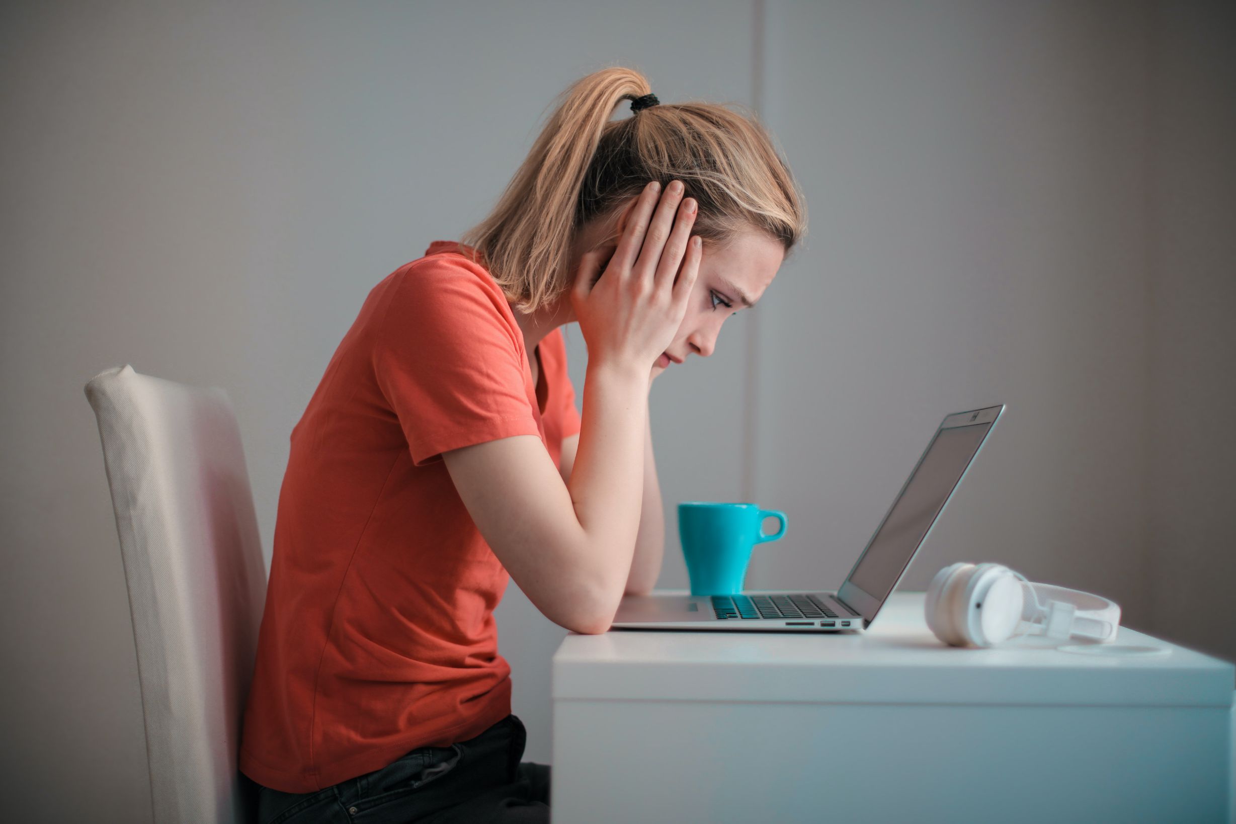 Troubled woman sitting in front of computer