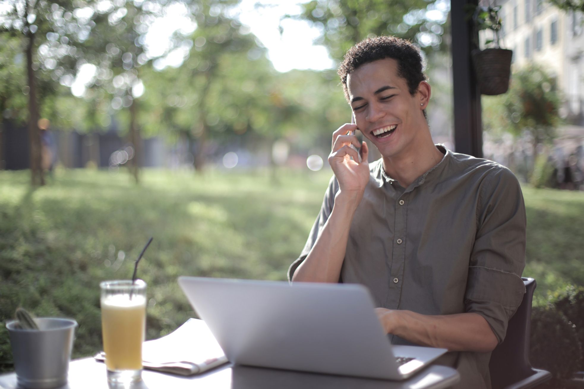 Person talking on phone looking at laptop