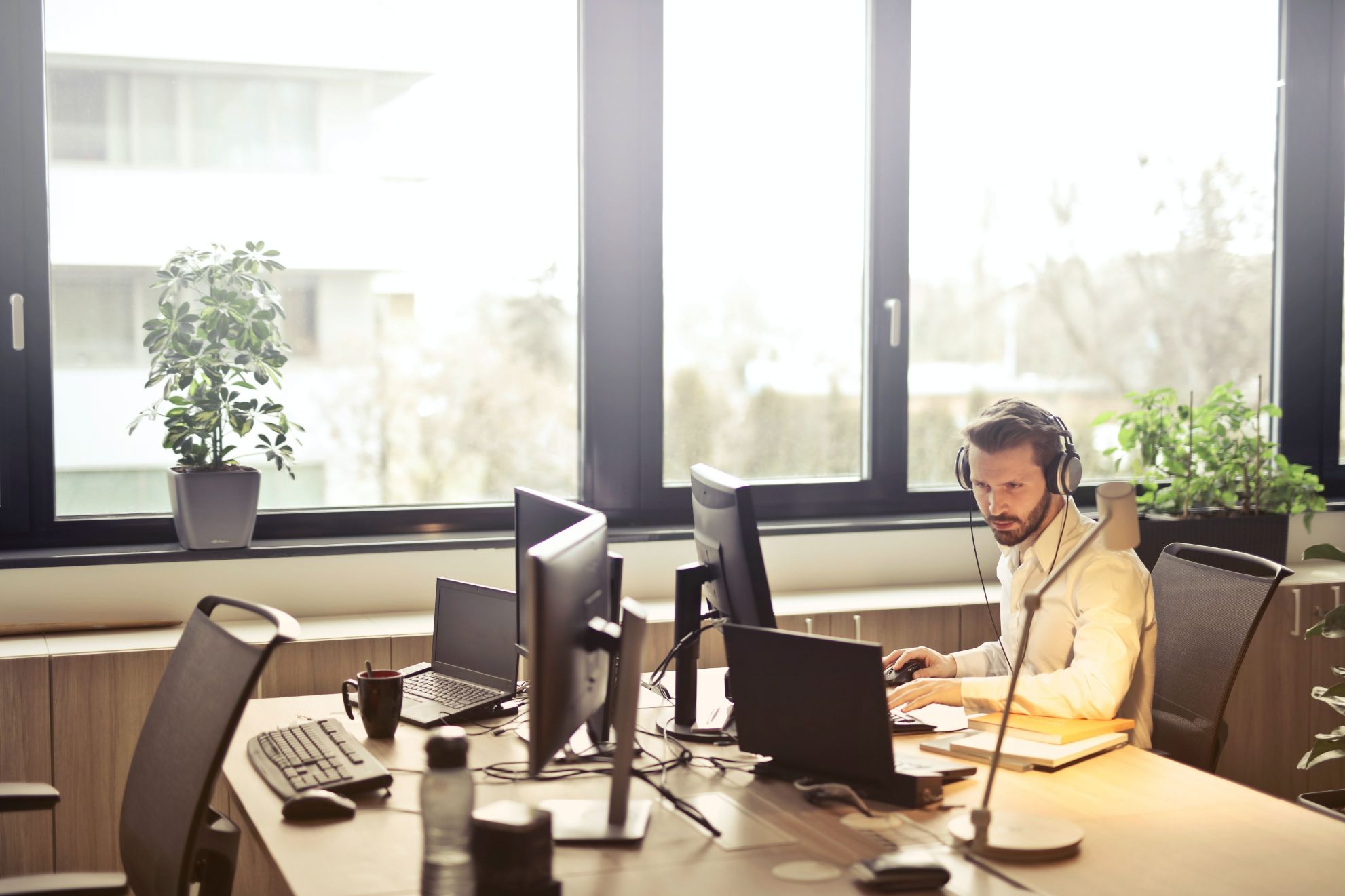 man with headphones on a computer