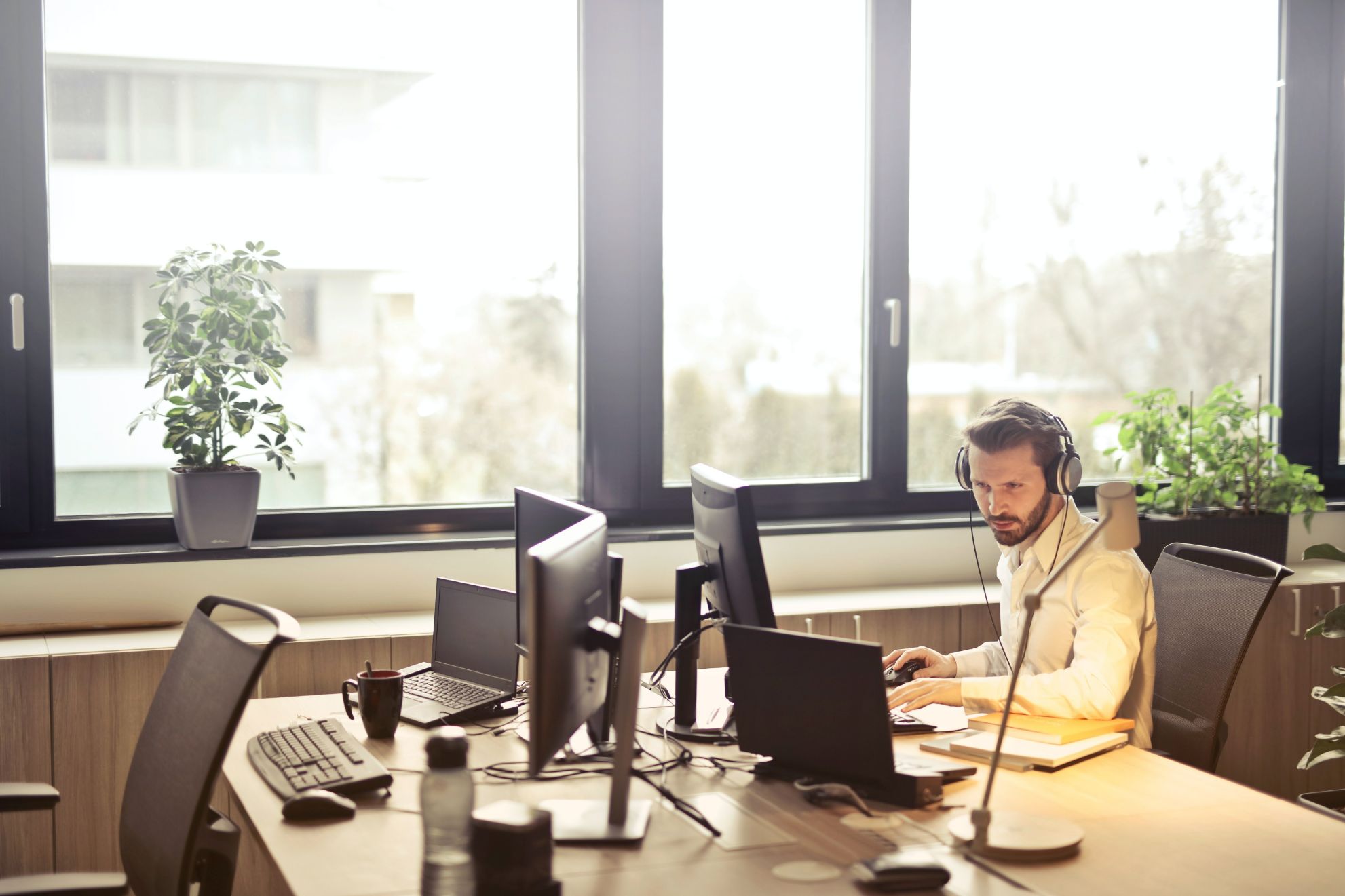 man with headphones on a computer 