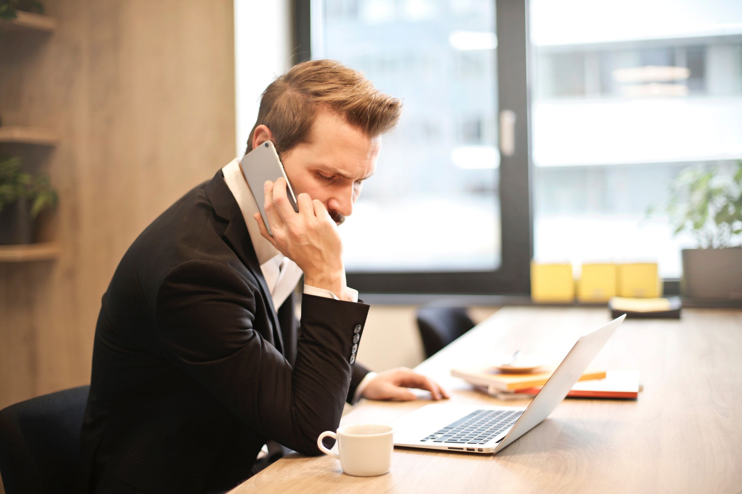 Man on a phone call at a desk 