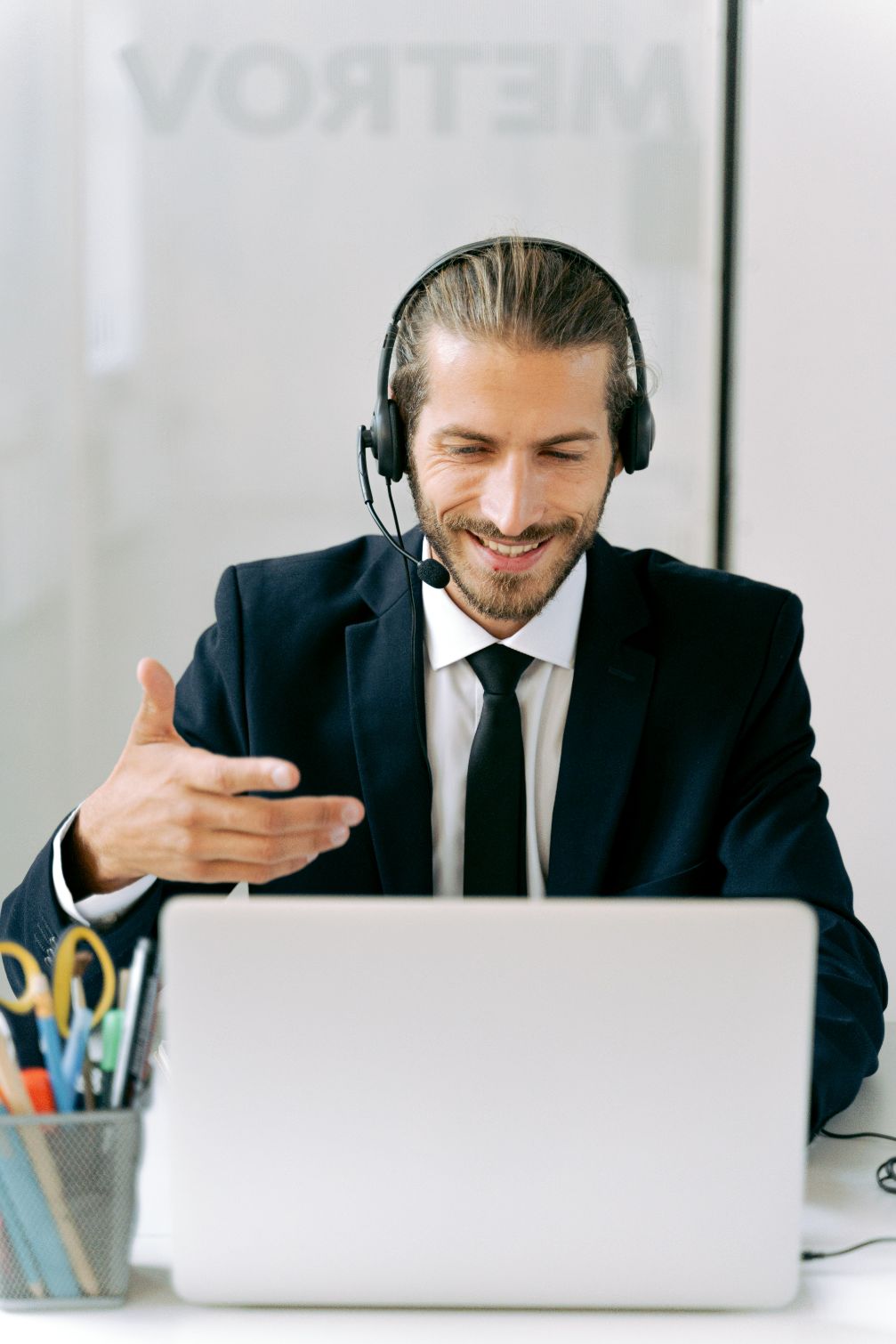 Person looking at computer screen wearing a headset