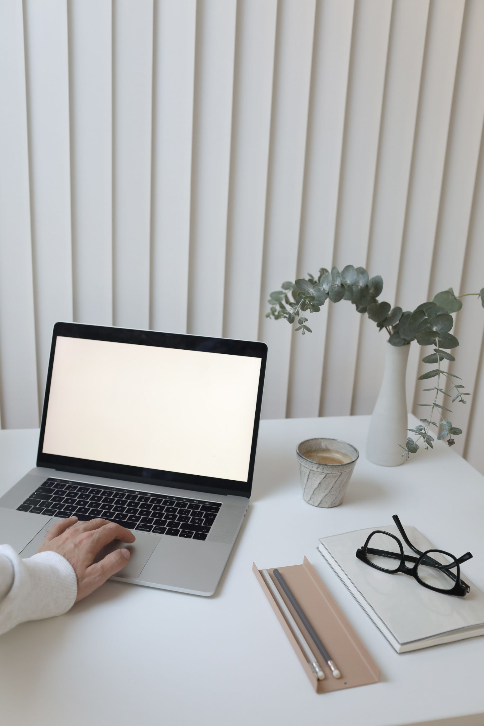 Person browsing laptop on a desk