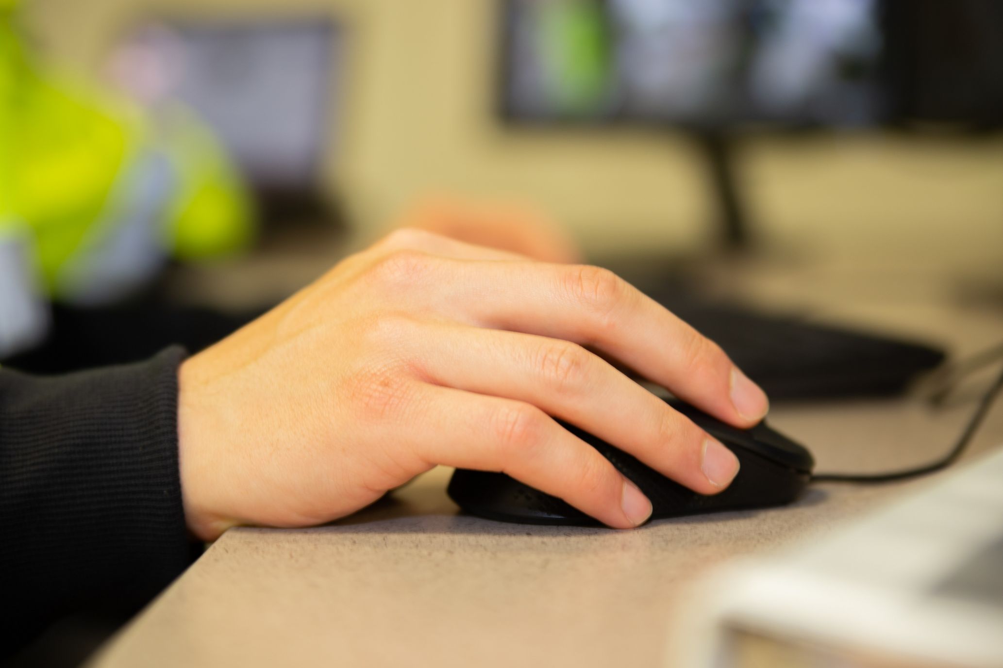 Person holding computer mouse