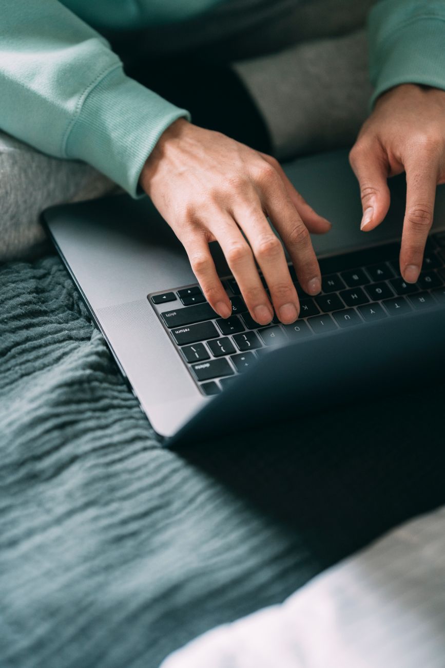 Crop person typing on a computer