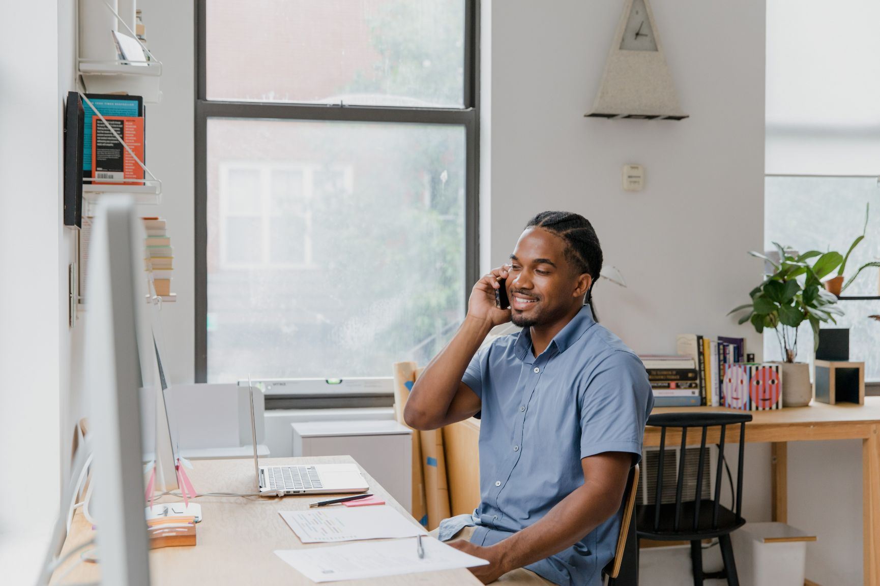 Person sitting at desk talking on phone