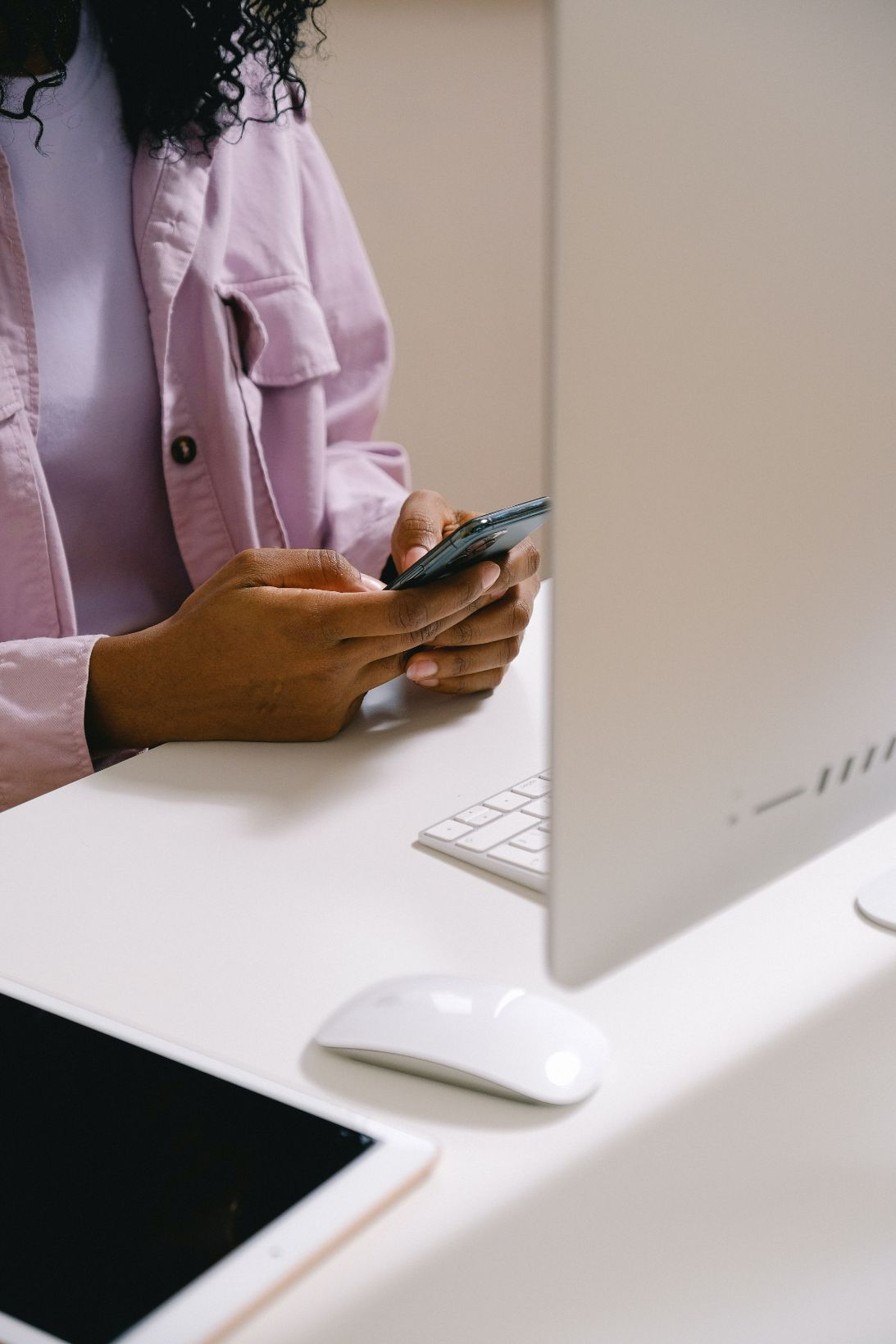 Woman on phone in front of computer screen