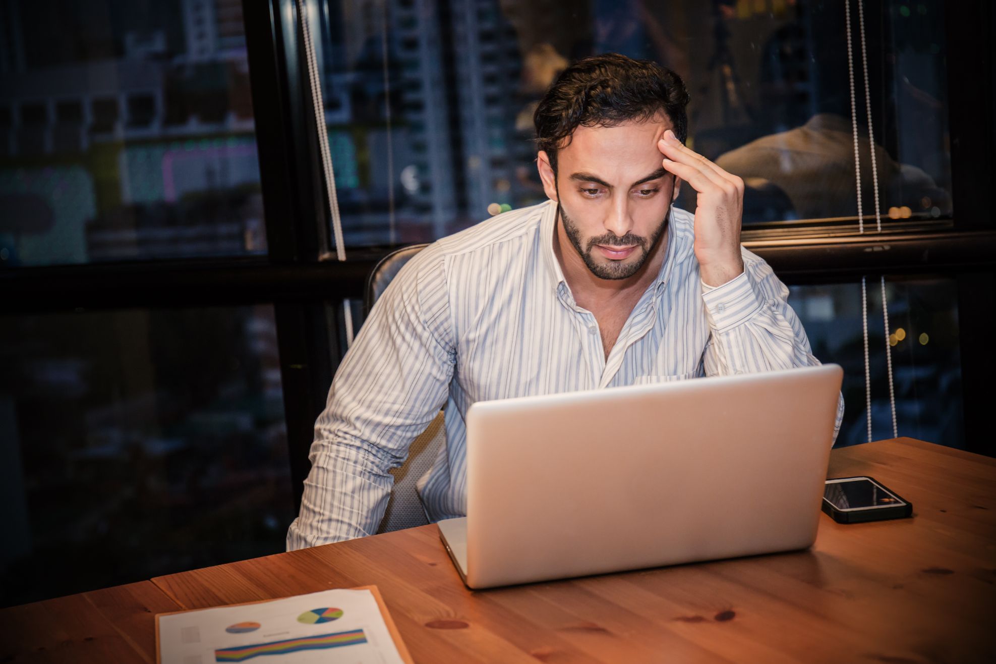 Frustrated business man on computer working at a desk