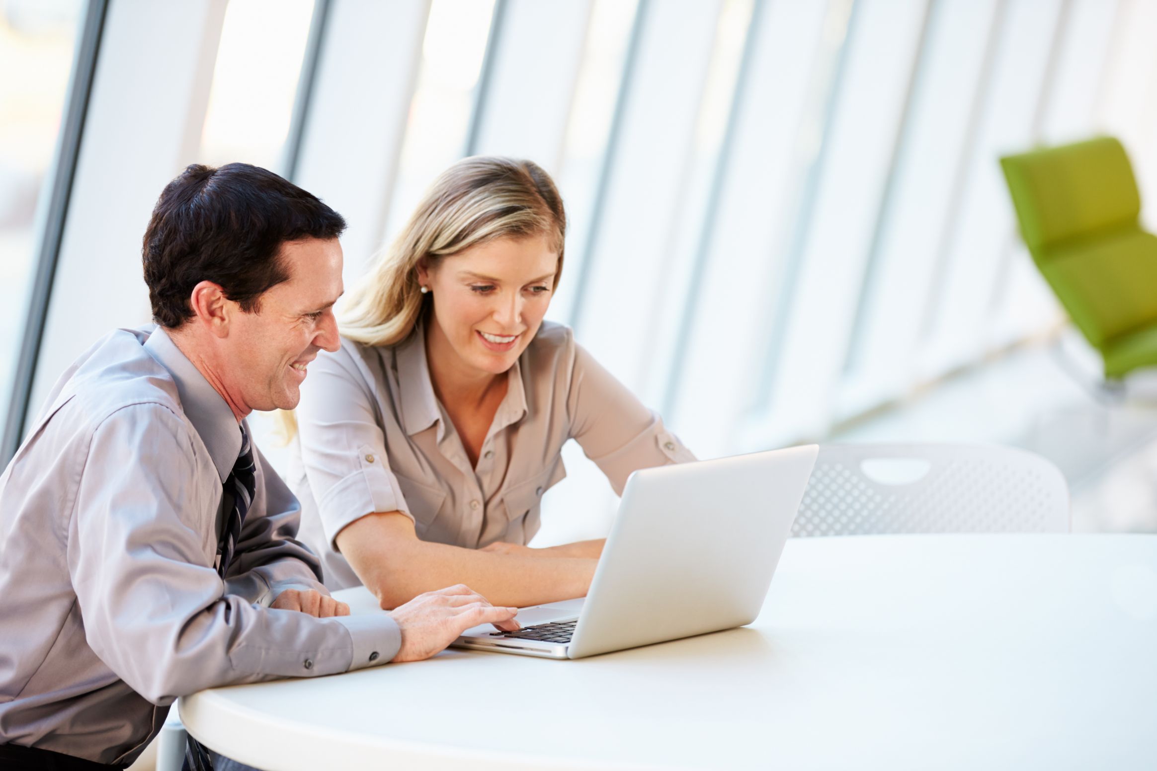 Business people working on a laptop at a desk