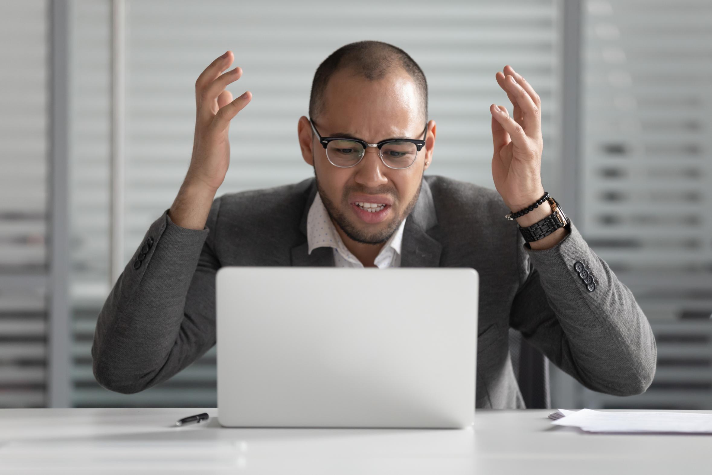 Frustrated business man working on computer