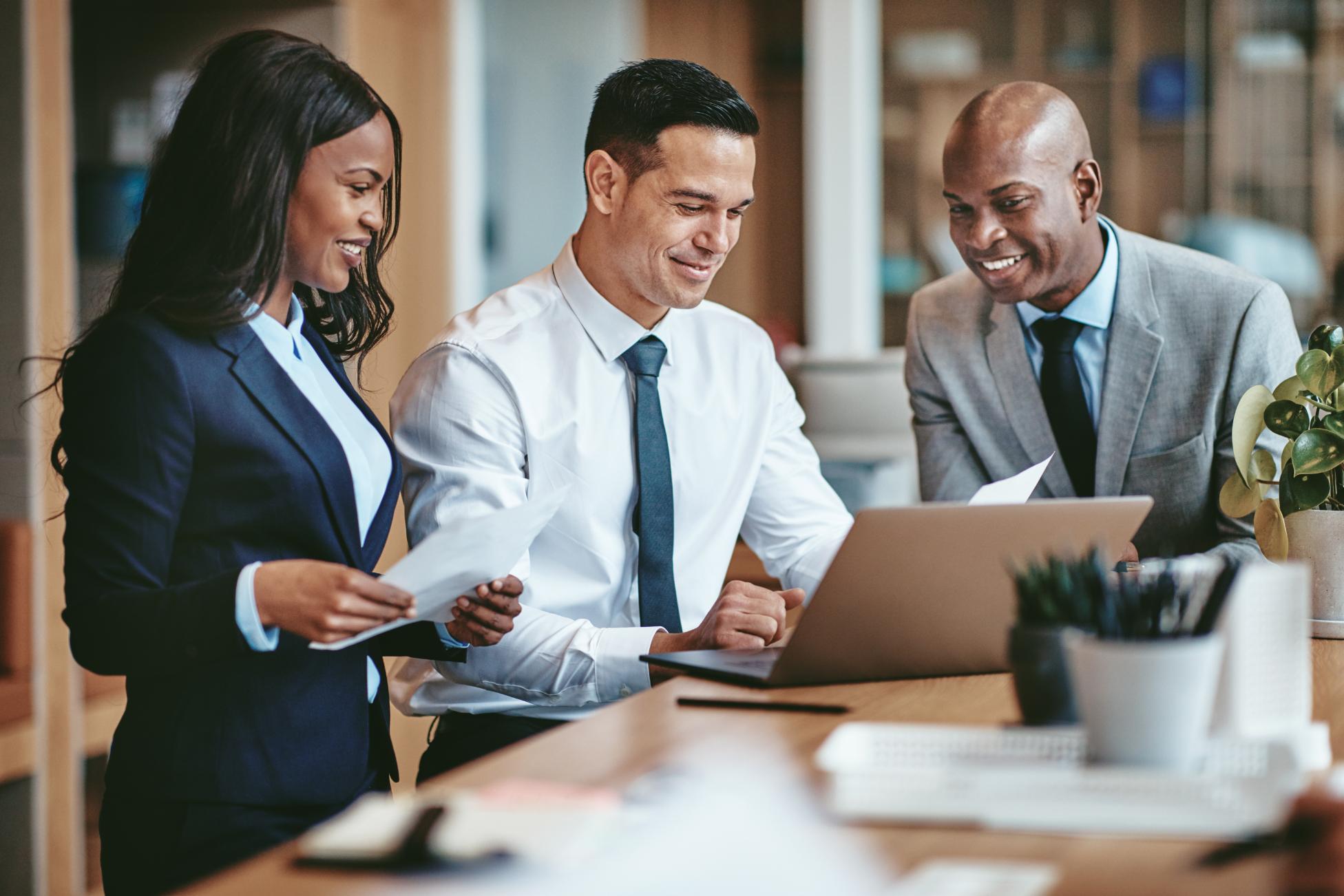 Business people working on laptops at a table