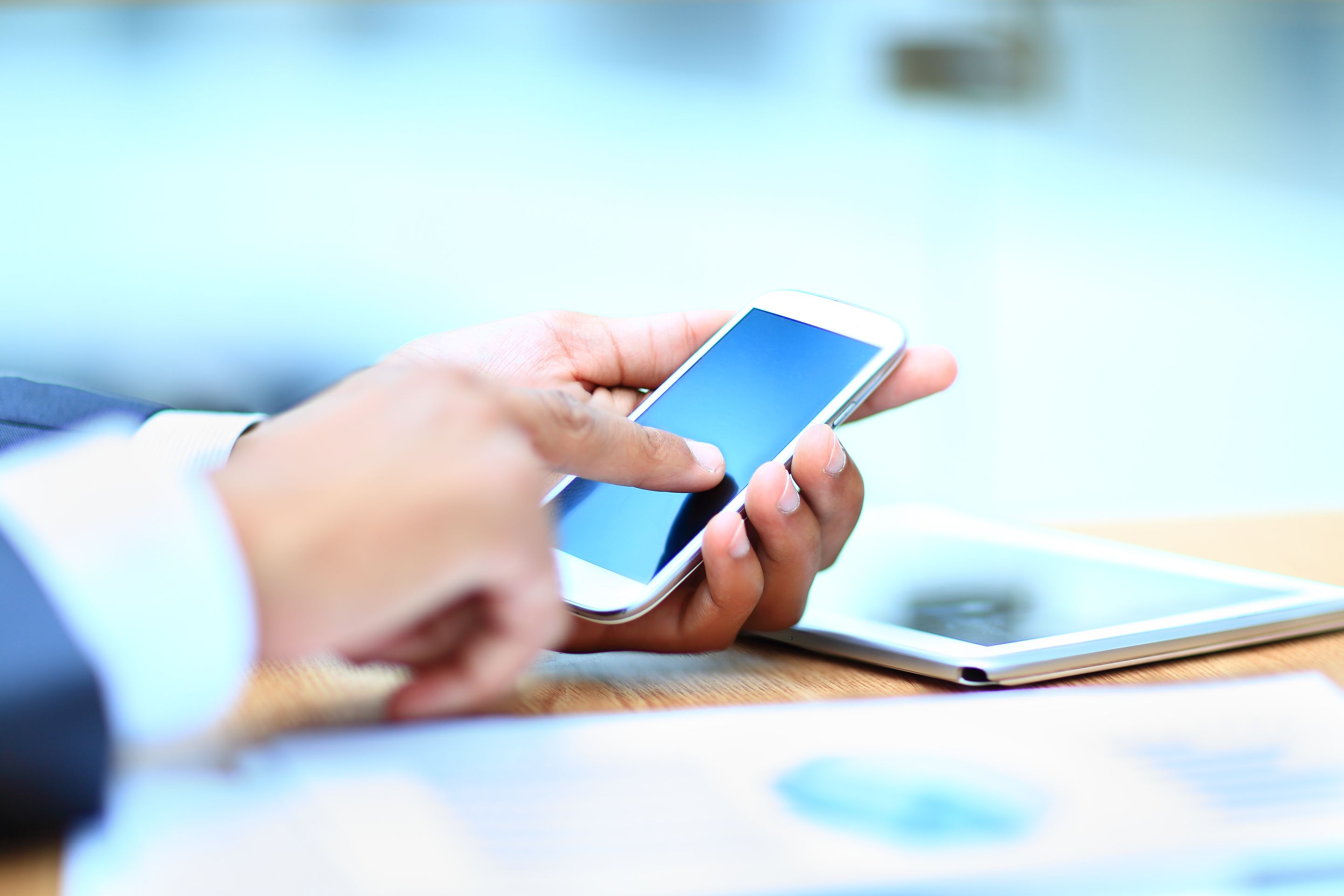 Close up of person's hand holding and scrolling on cellphone