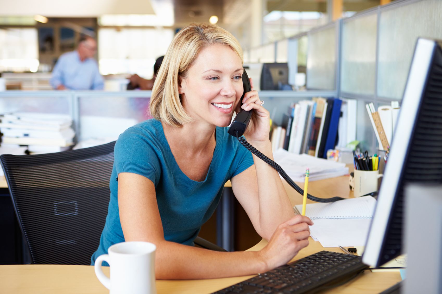 Business woman talking on phone working in an office