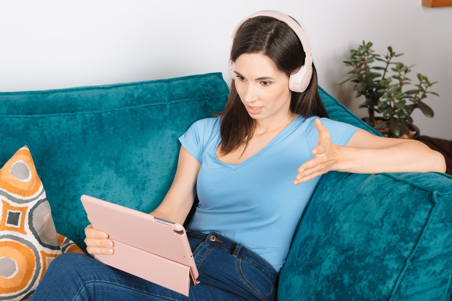 Lady talking on computer with headphones on 