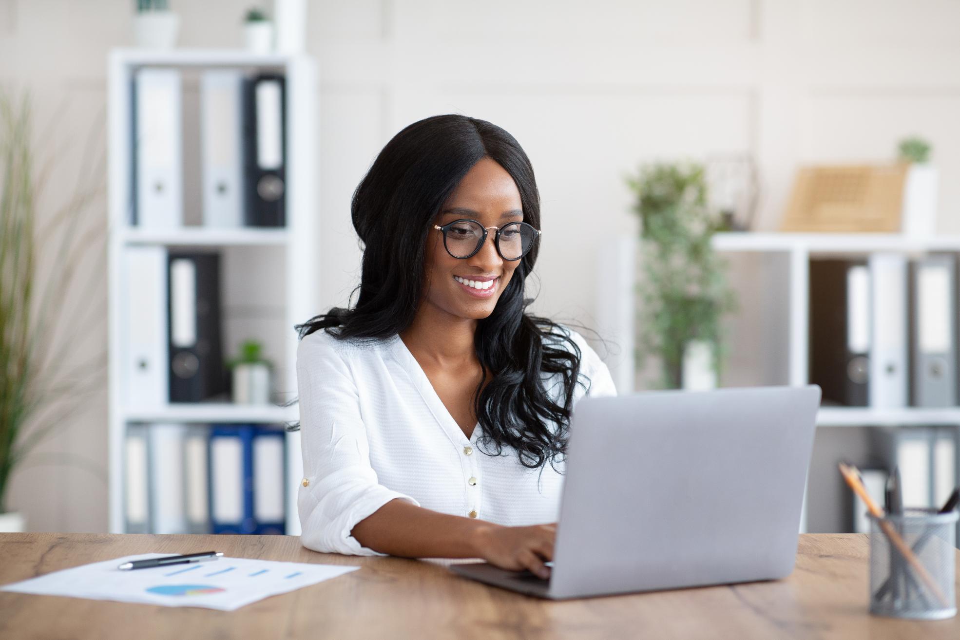 Business woman working on laptop at a table