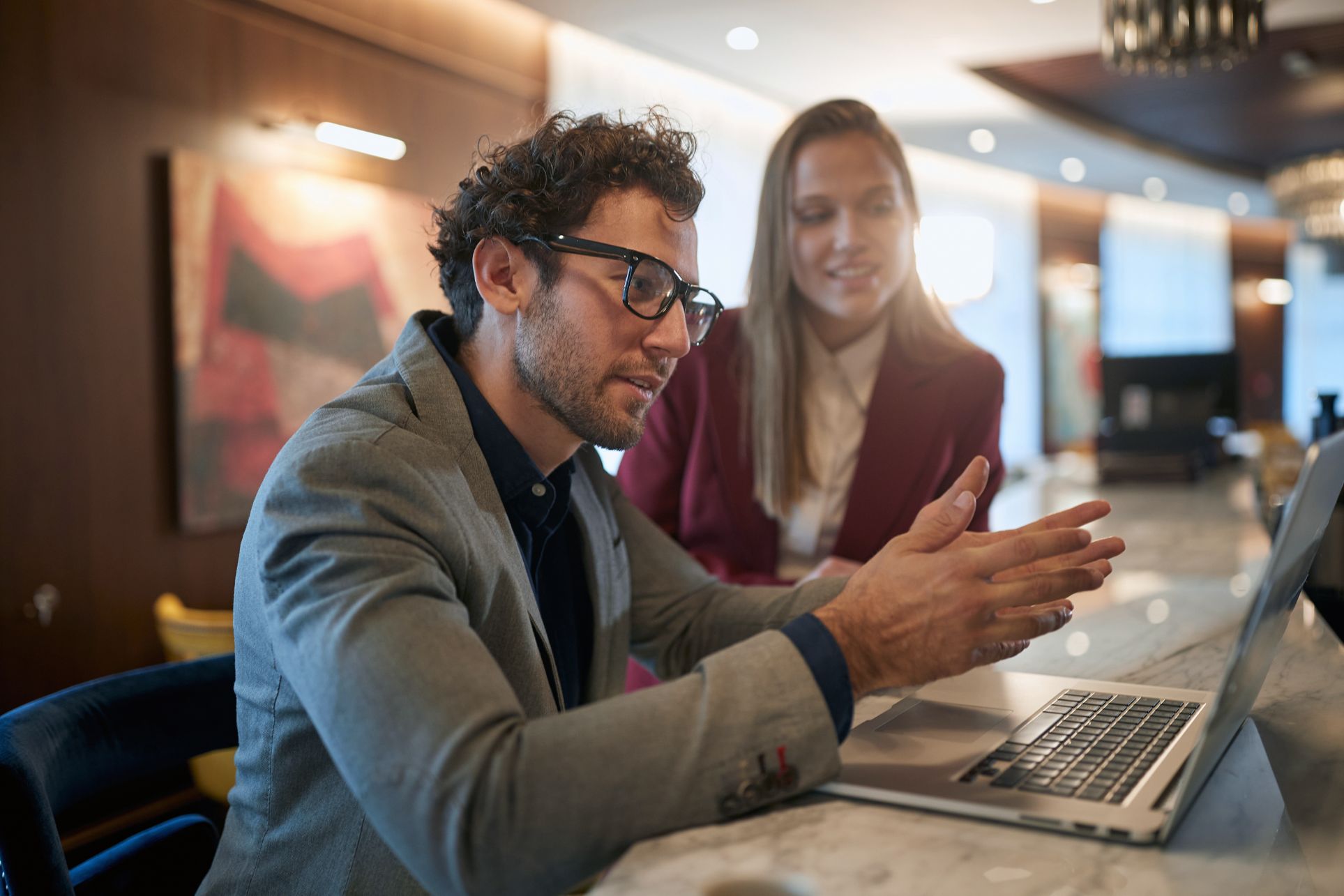 Two business people working on computer at a desk