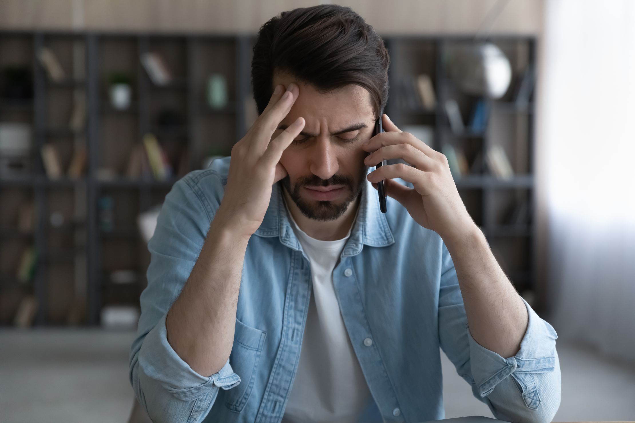 Frustrated business man talking on cellphone