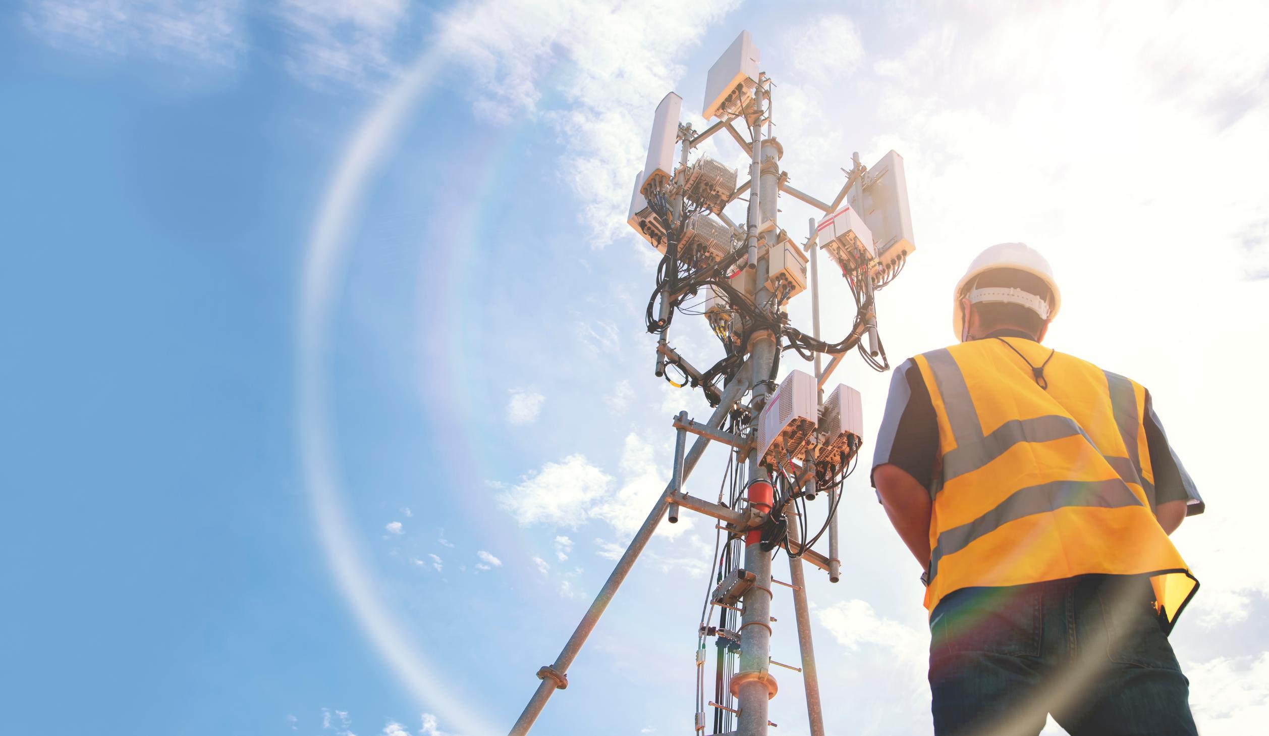 Construction worker working on wireless tower.