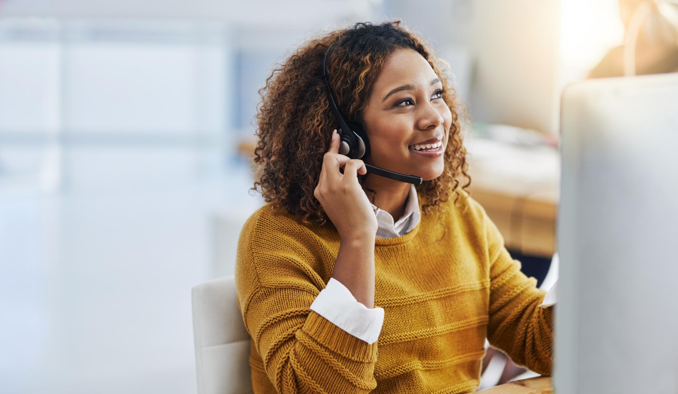 Business woman talking on a headset in a call center