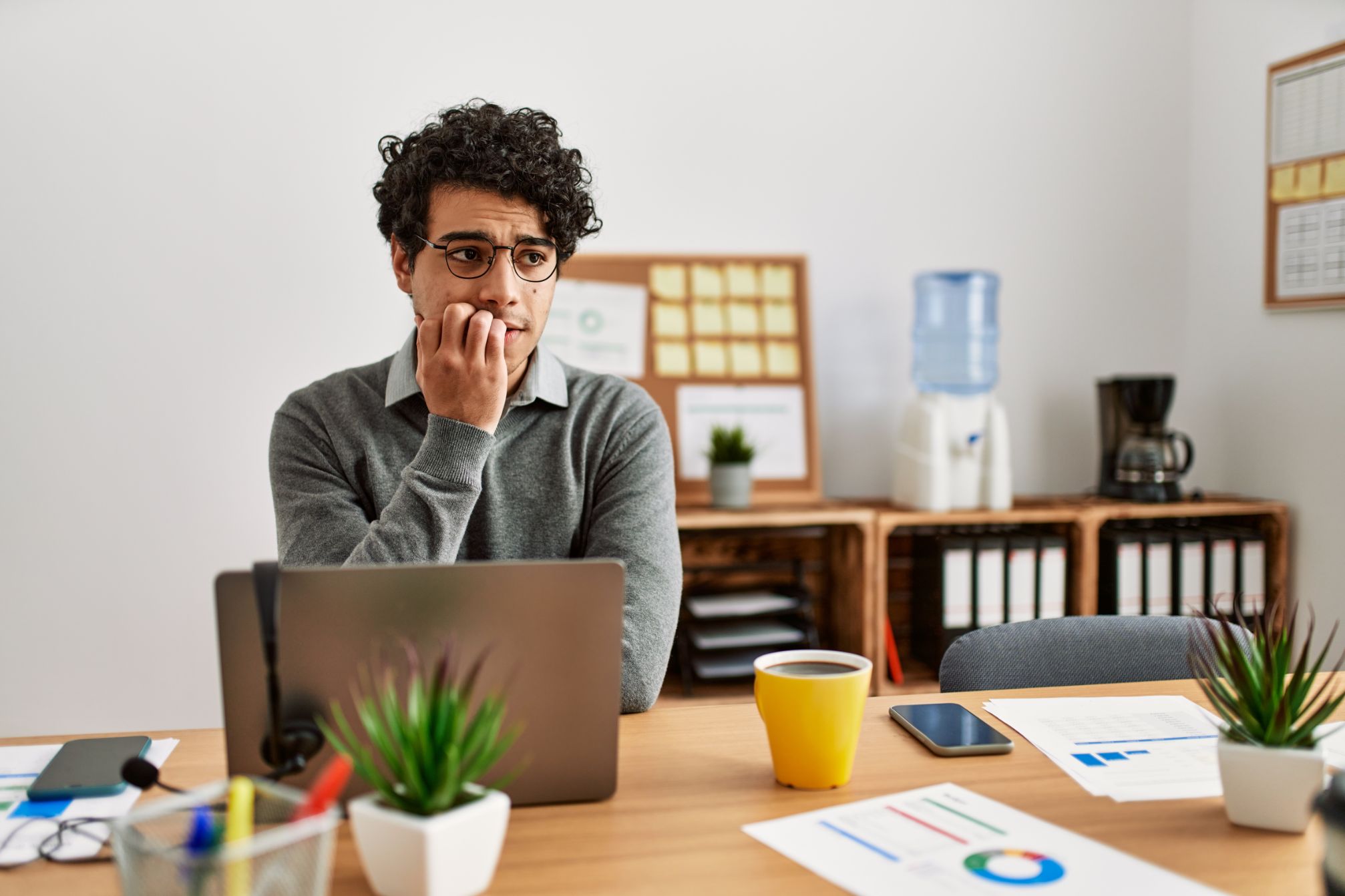 Nervous business man working at a computer