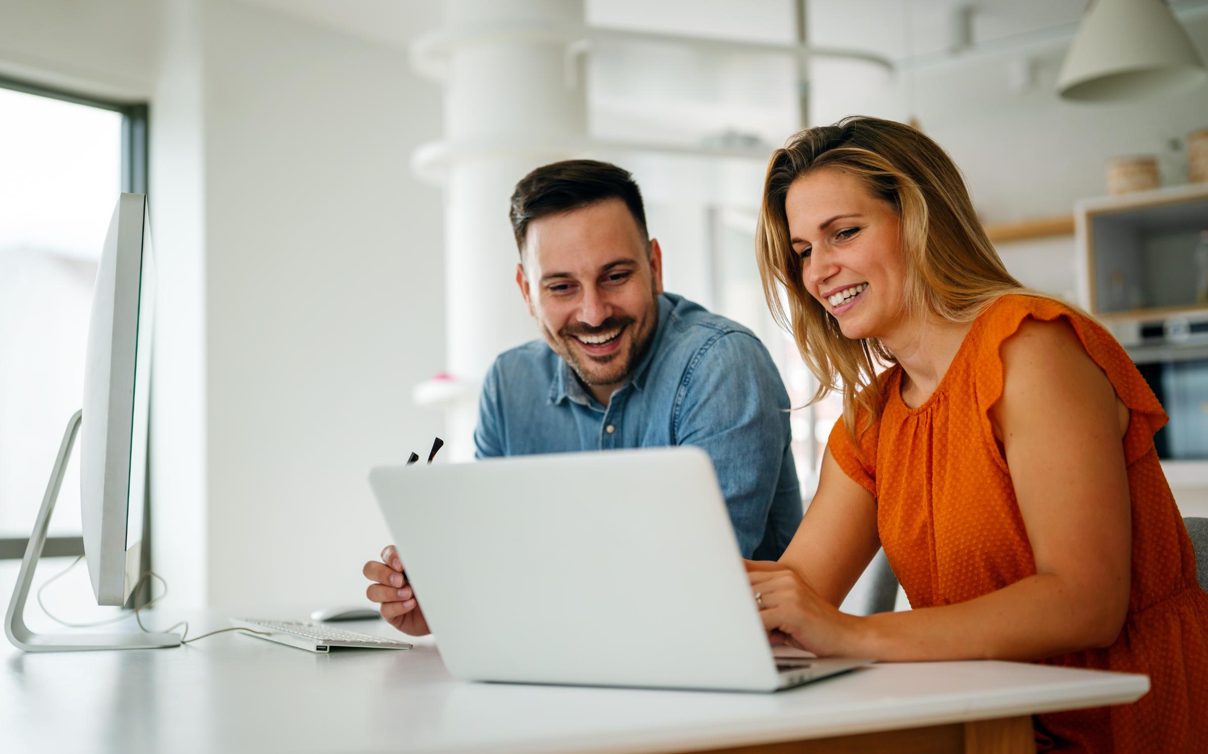 Business people working on a laptop together at a table