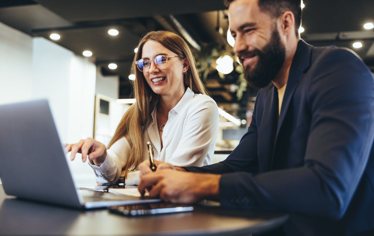 Two business people working on computer at a desk