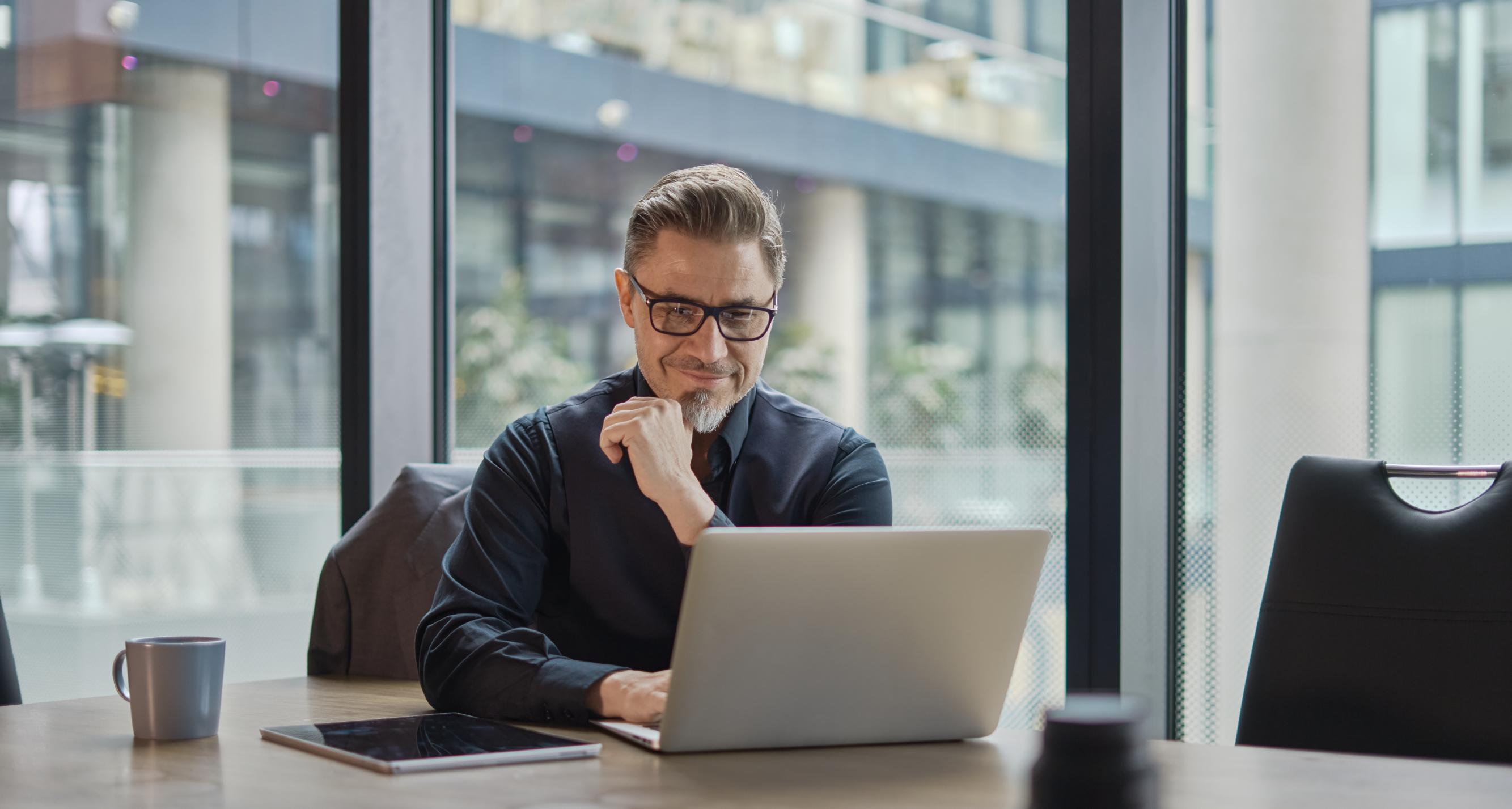 Business man working on a laptop at a table