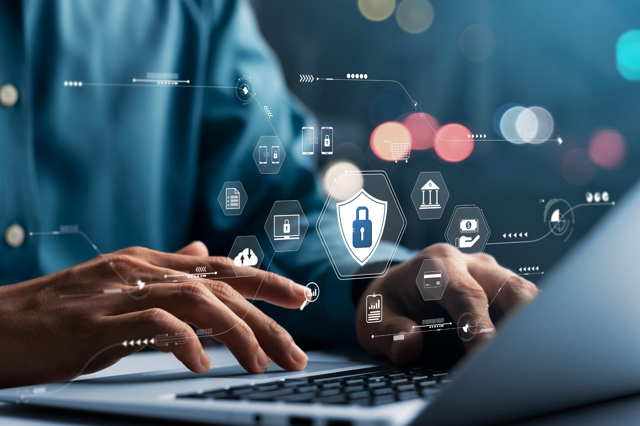 Business person working on computer with a security emblem over the image