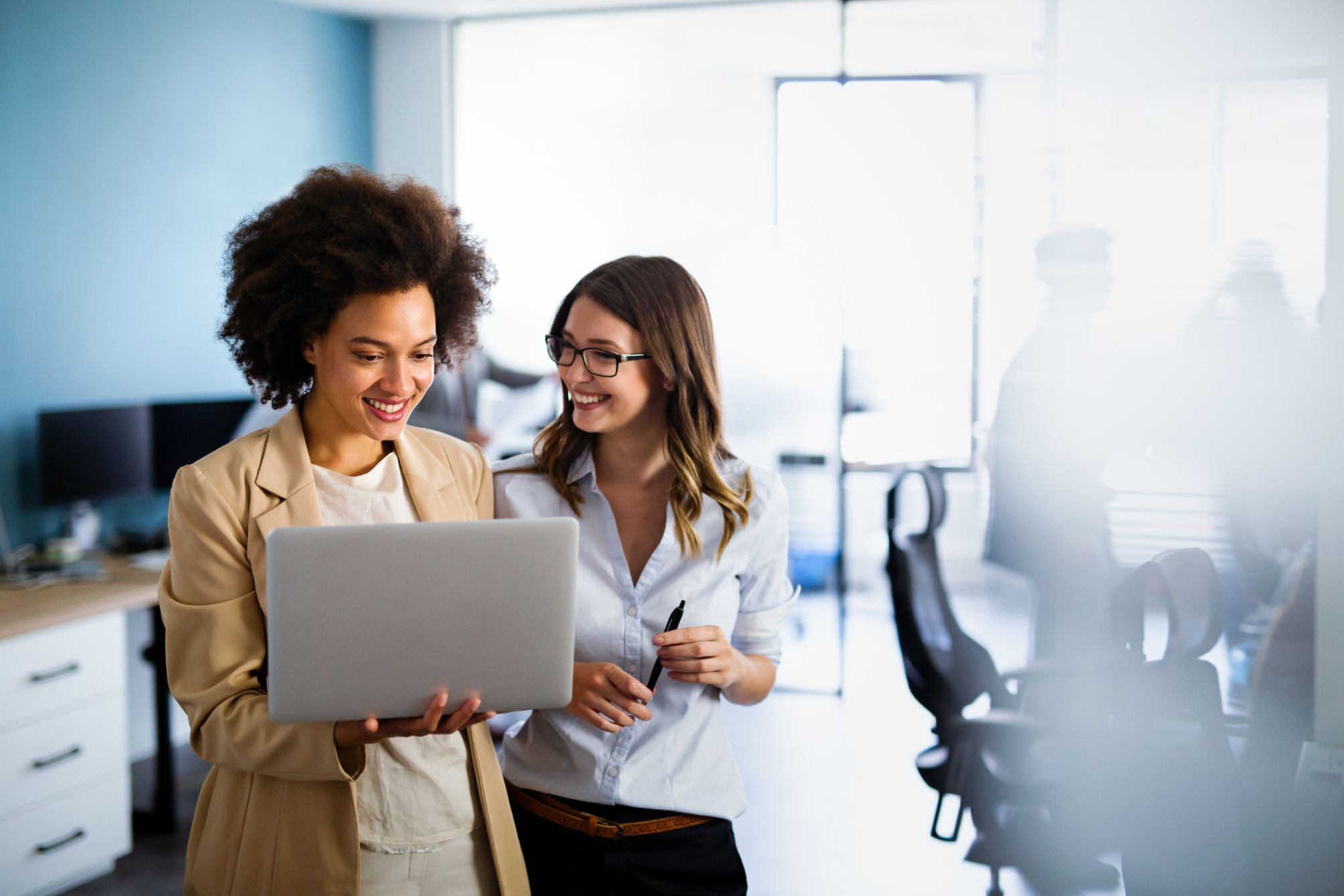 Two business woman working on a laptop together