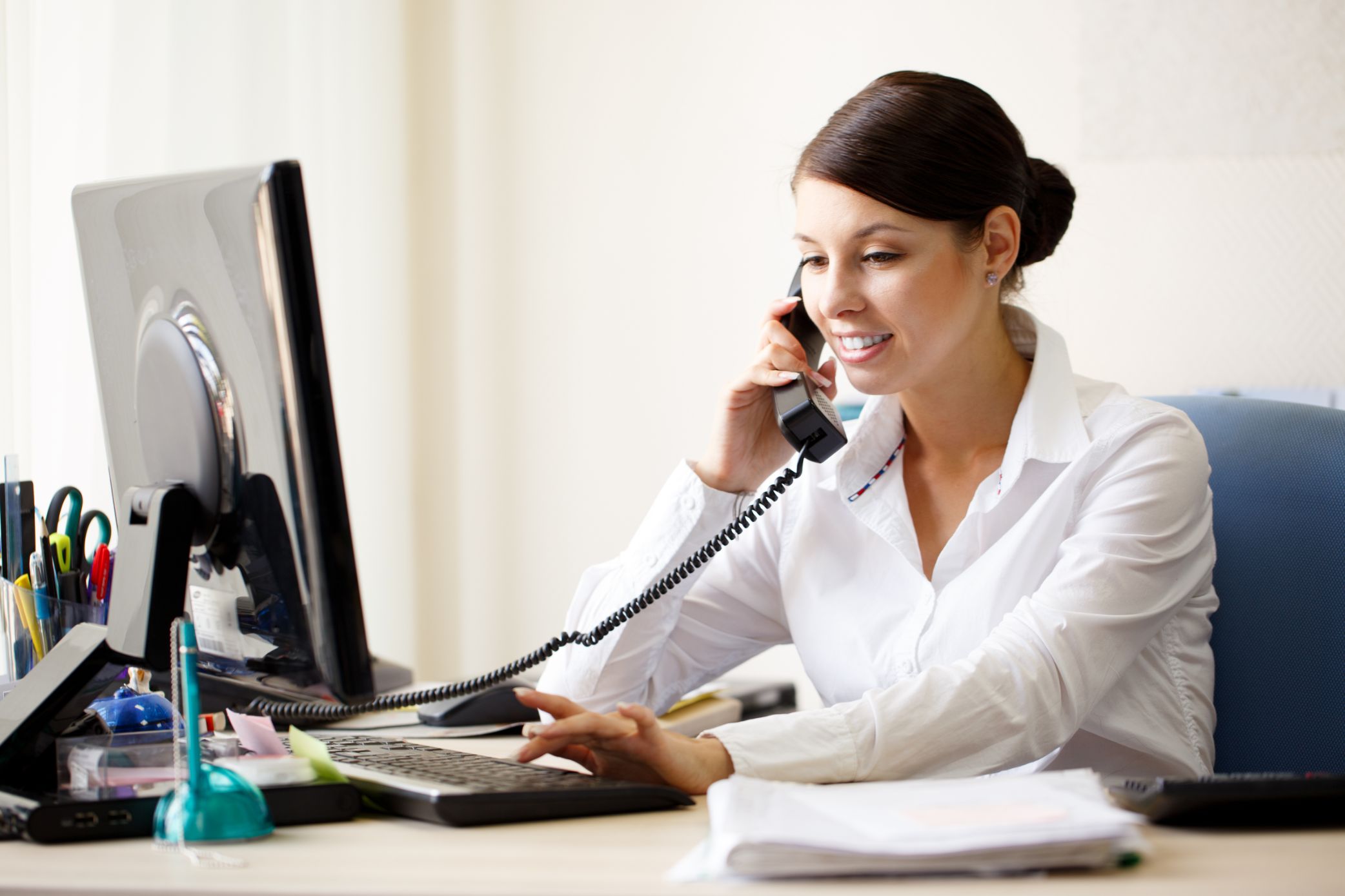 Business woman talking on phone in an office