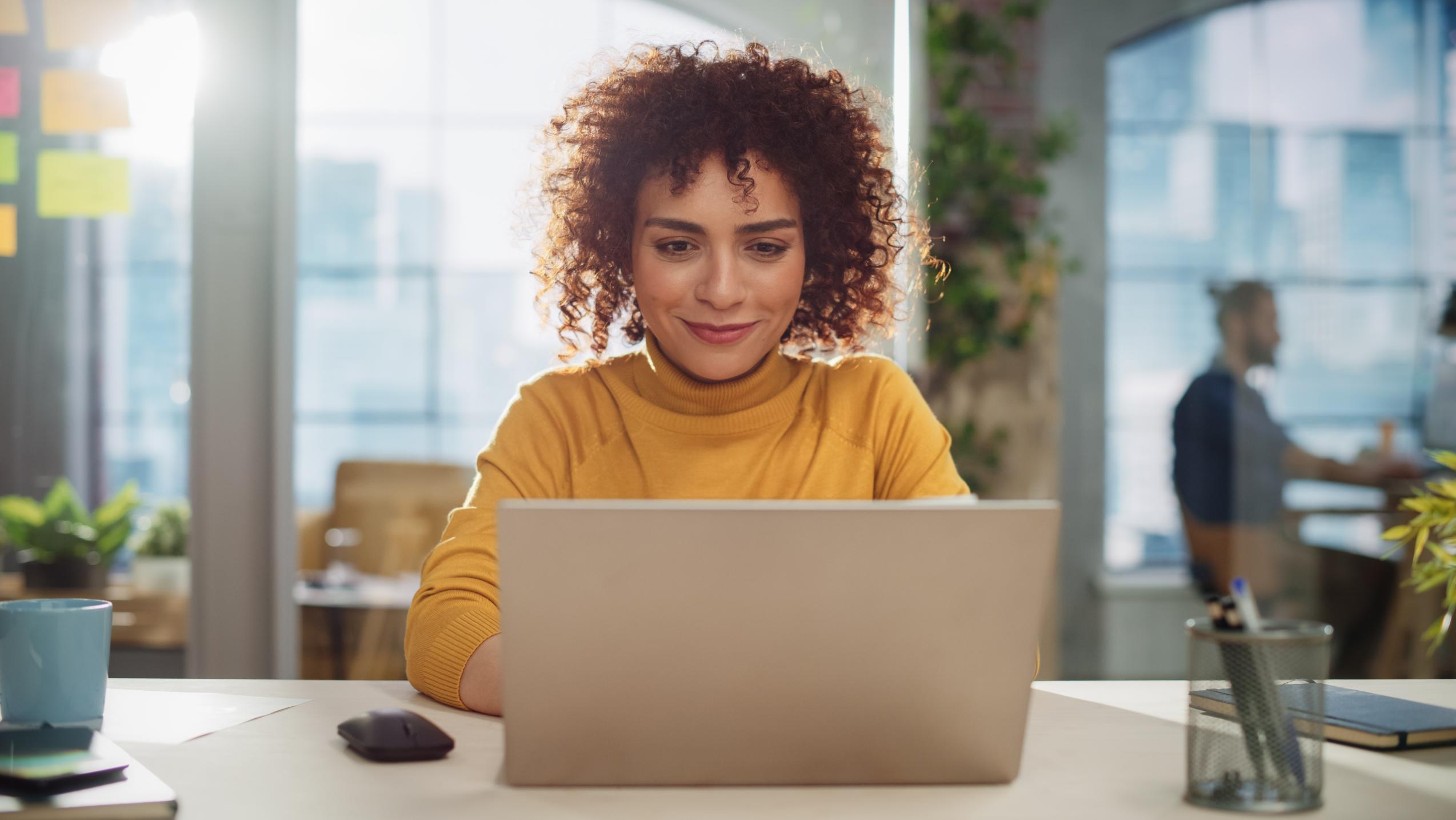 Business woman working on laptop at a desk 