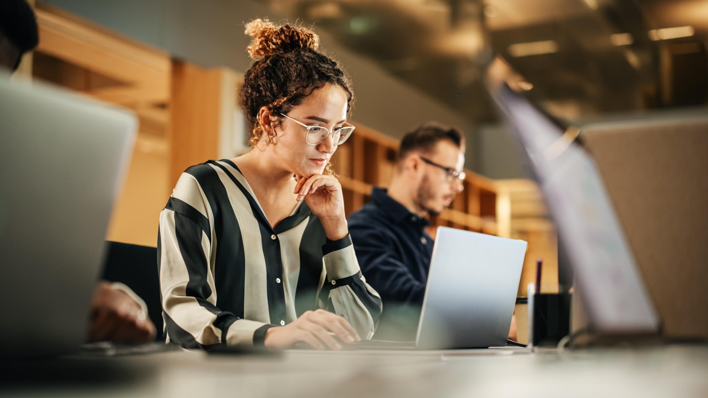 Business woman working on a laptop at a table