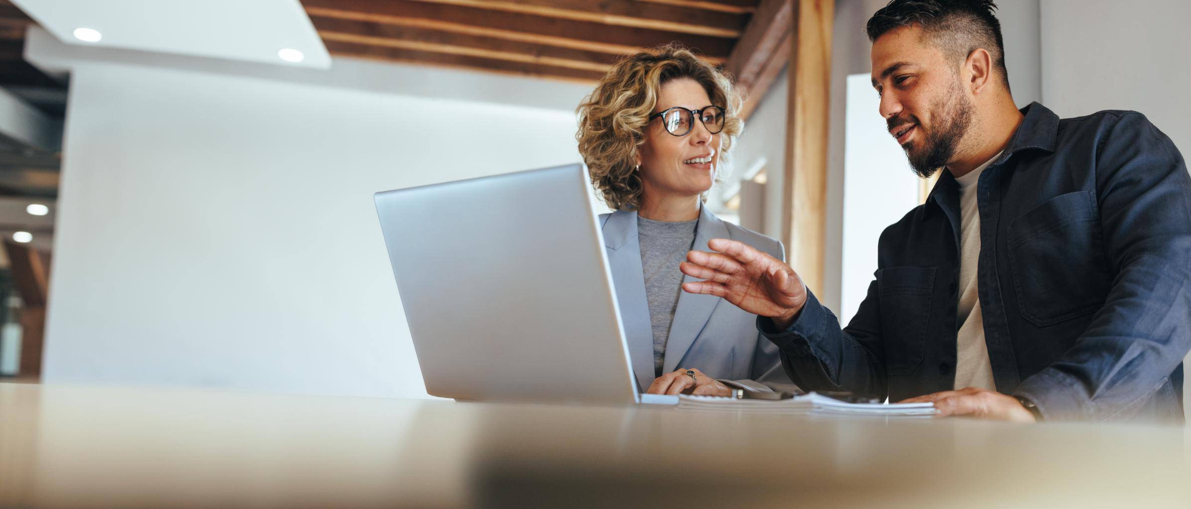 Business people working on a computer at a desk together