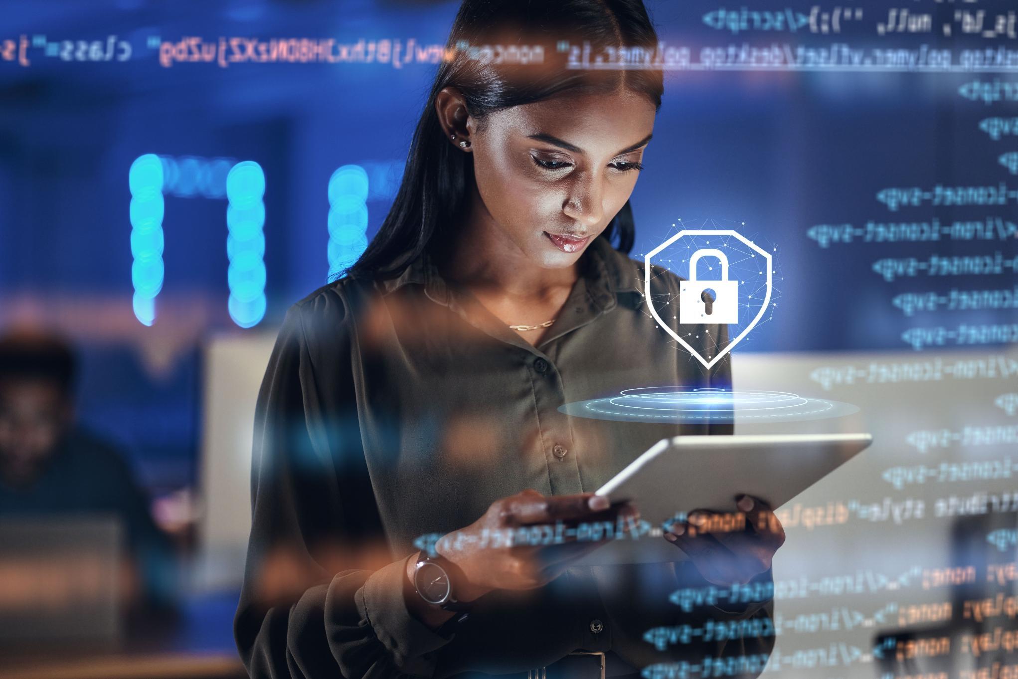 Person working on tablet with a security logo over the image.