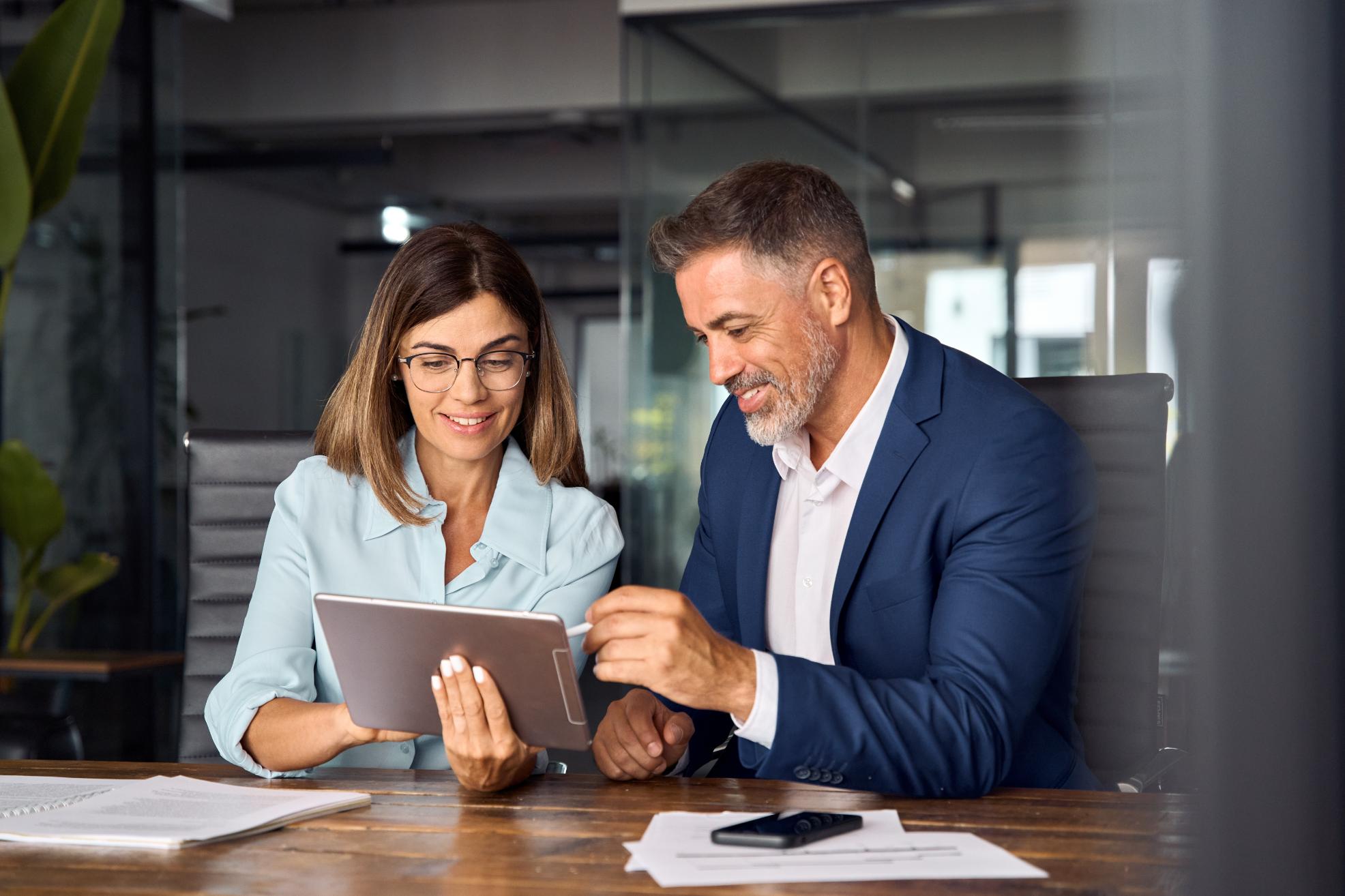 Business people working on a tablet at a table