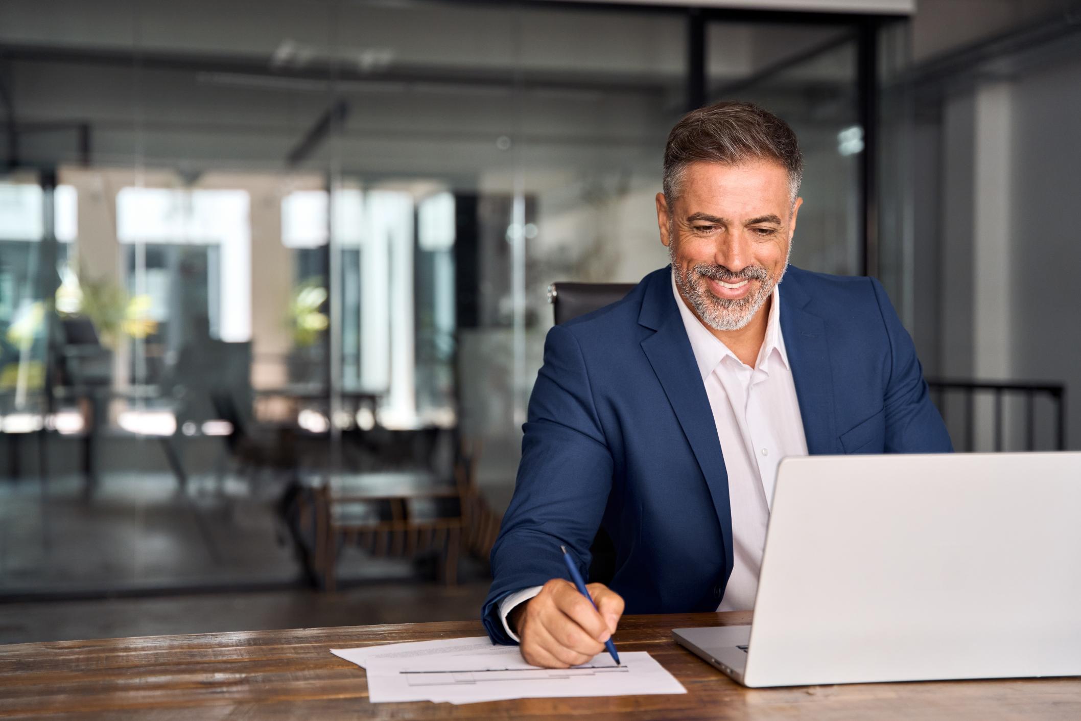 Business man working on a computer at a table