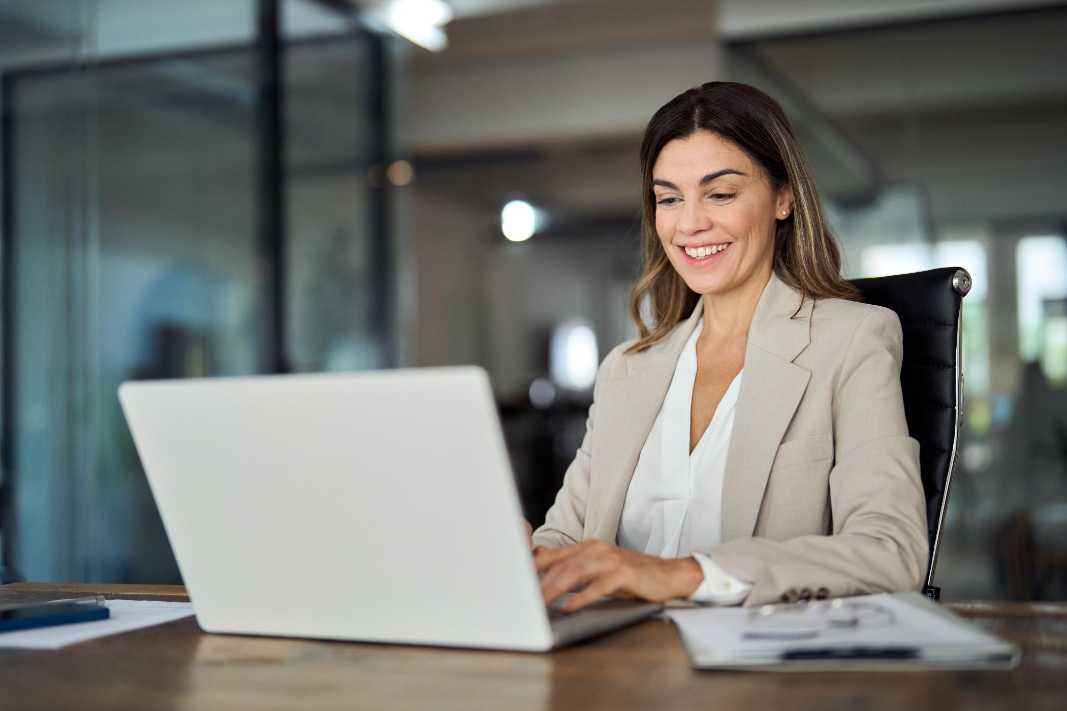 Business woman working on computer at a table