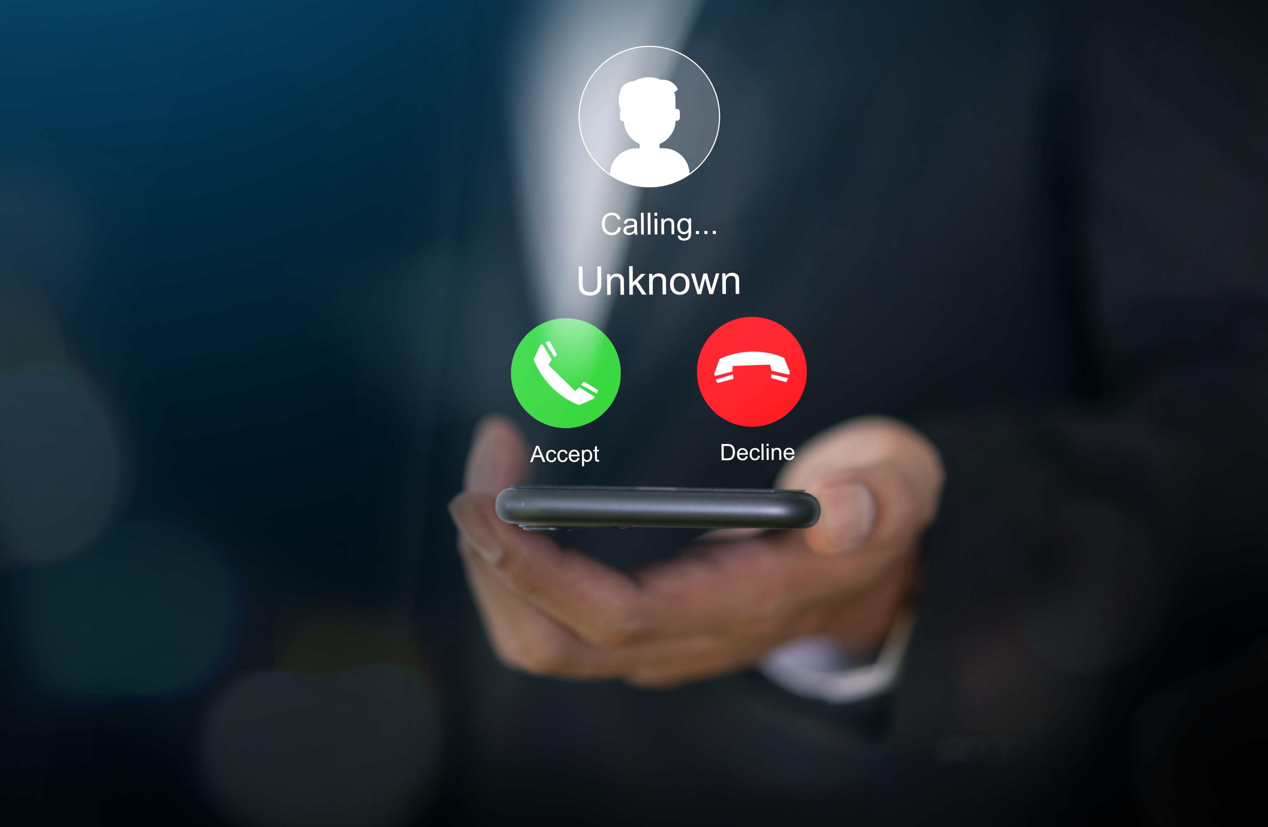 Person holding phone with an unknown call label