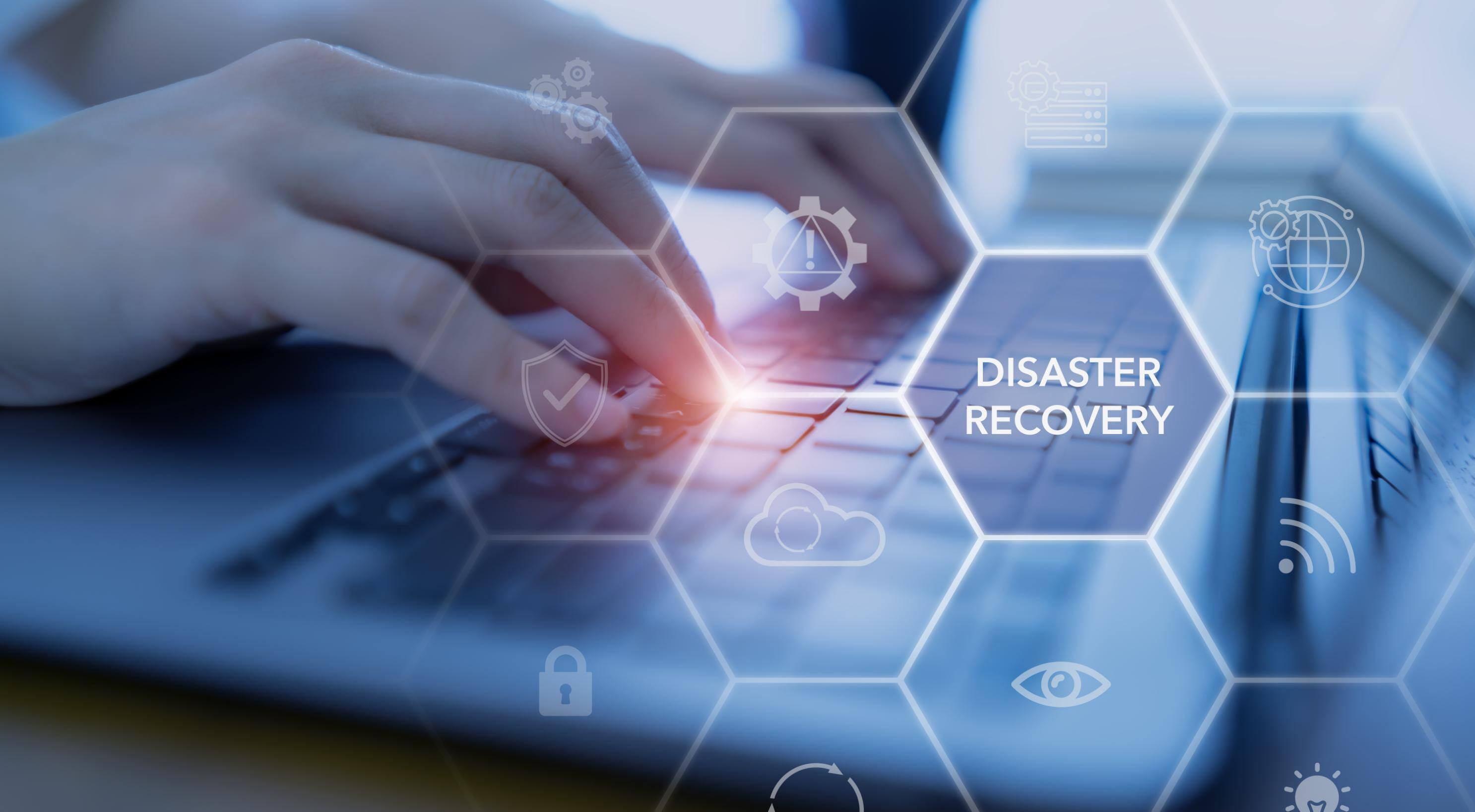 Person typing on computer with Disaster Recovery graphic over the image