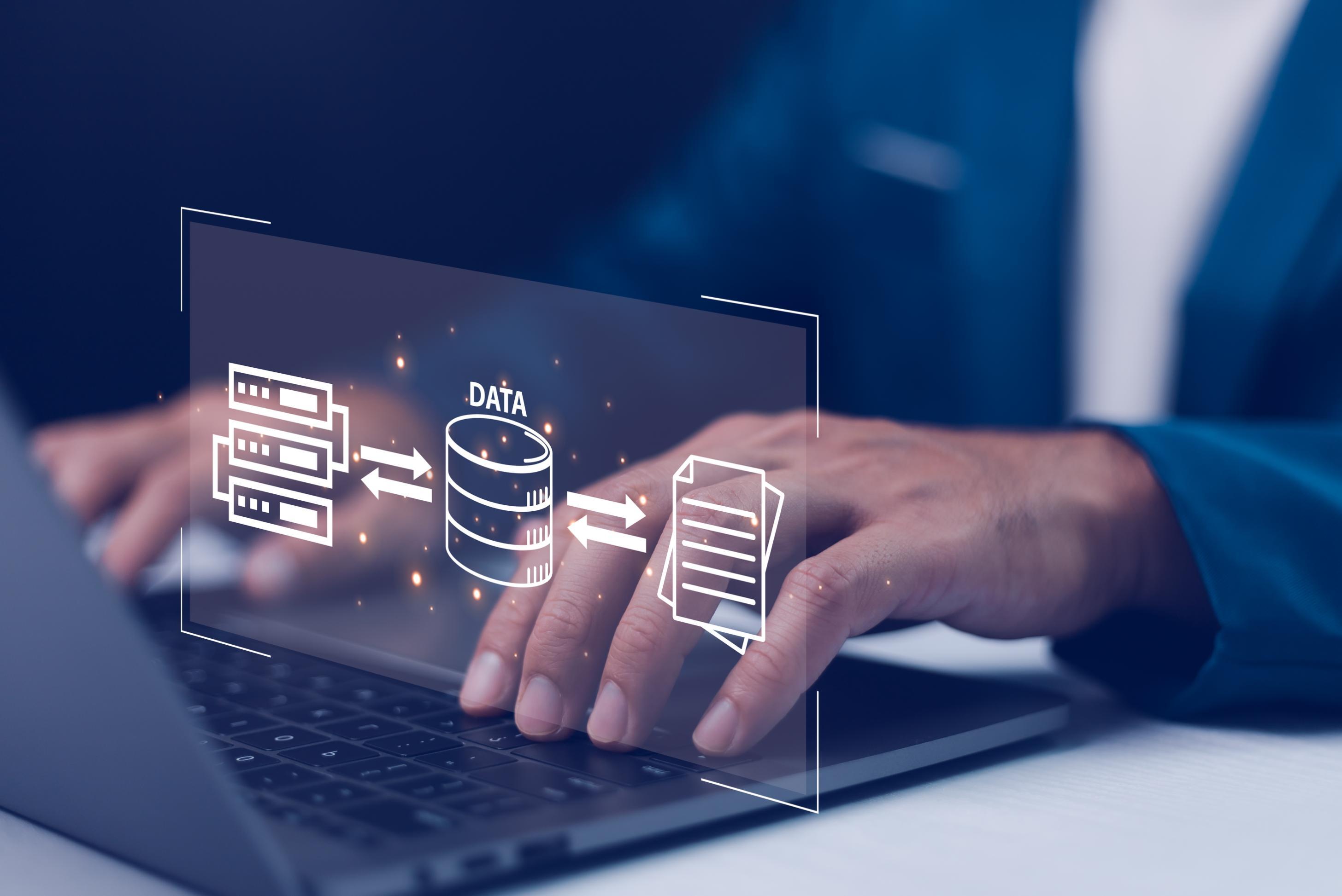 Person working on a laptop with data image over