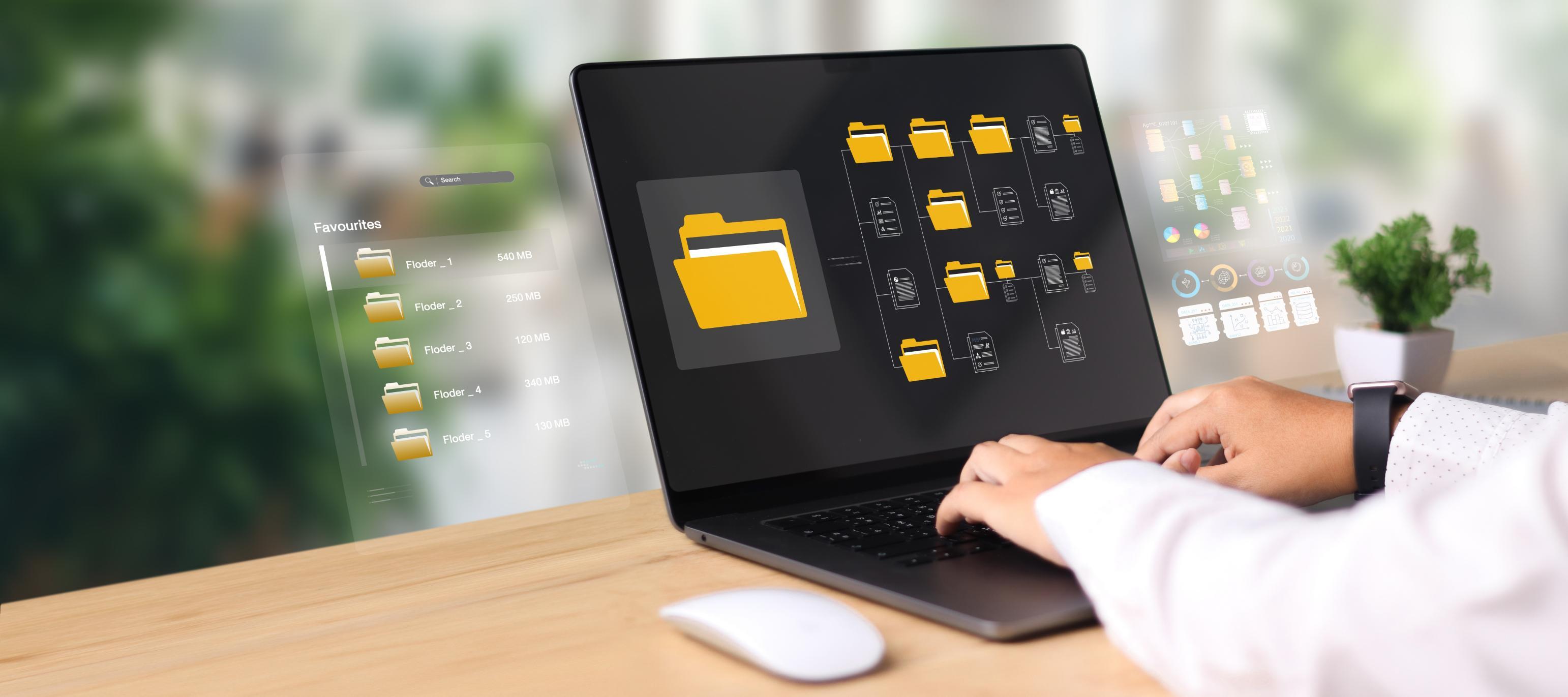 Person working on computer with file icons on computer