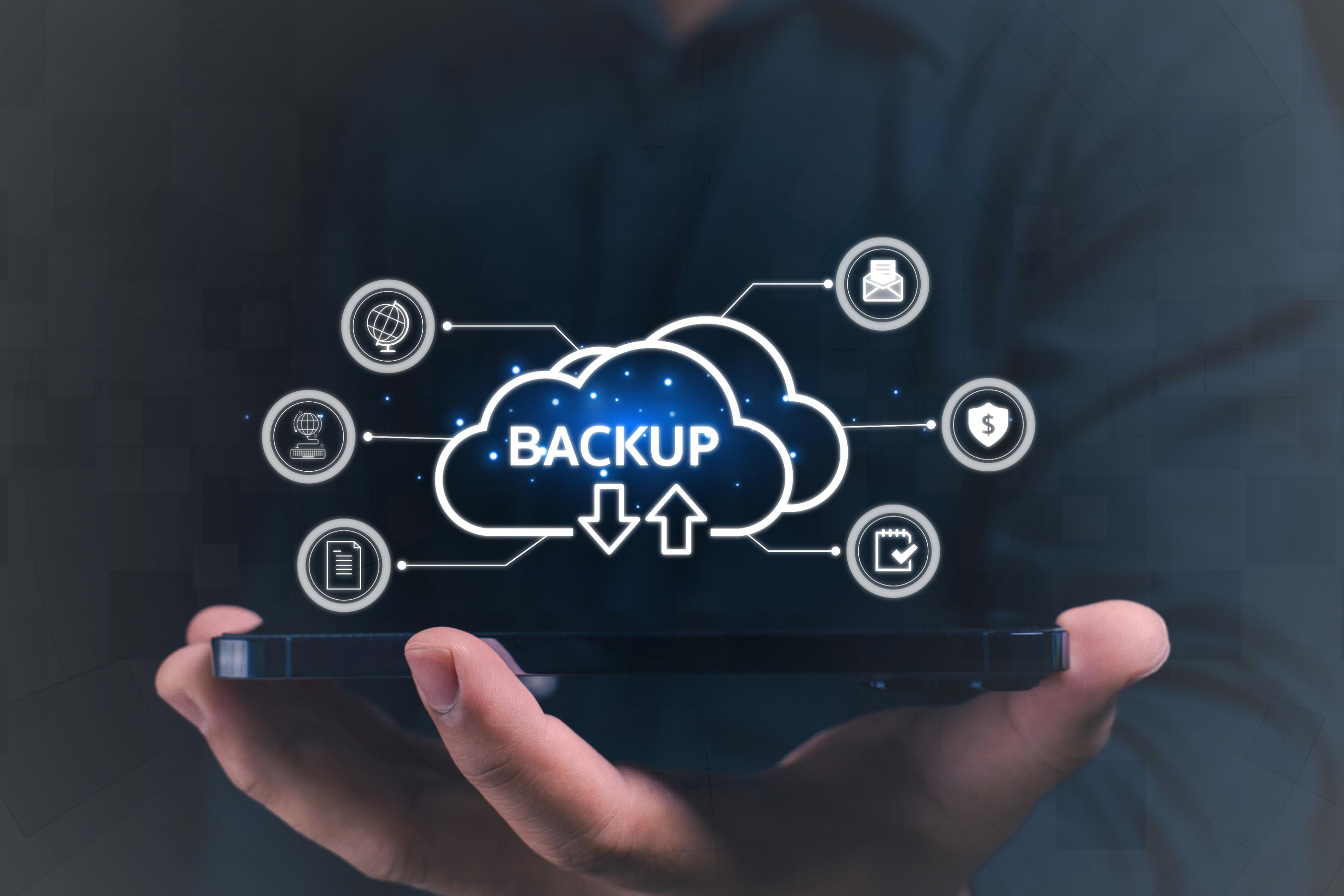 Human hand holding a cloud logo with the word backup