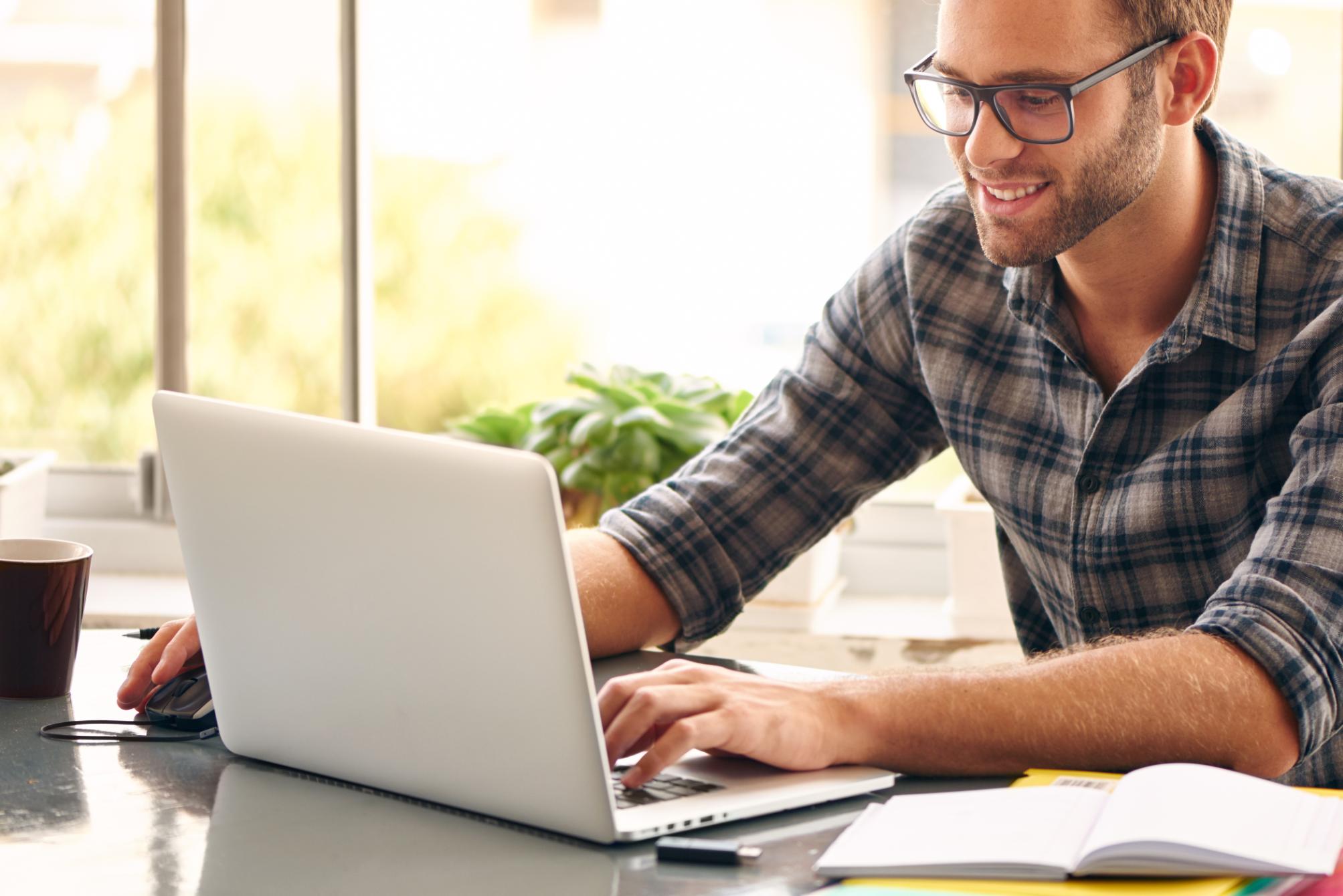 Business man working on computer at a table