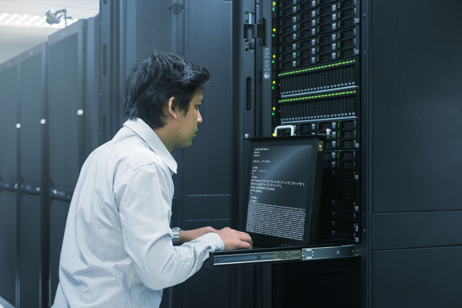 IT person working on a computer in a tech room