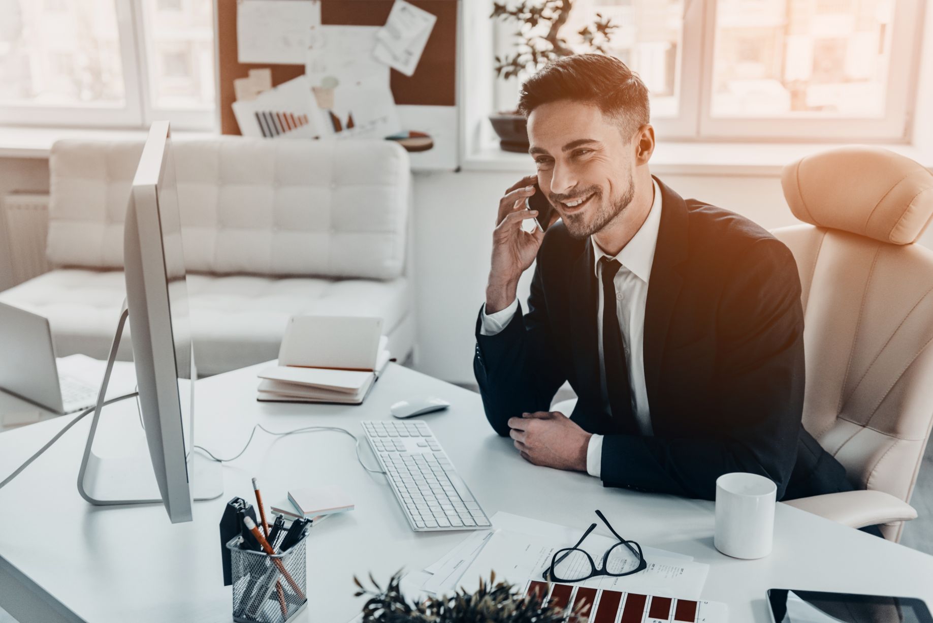 Business man on phone at a desk 