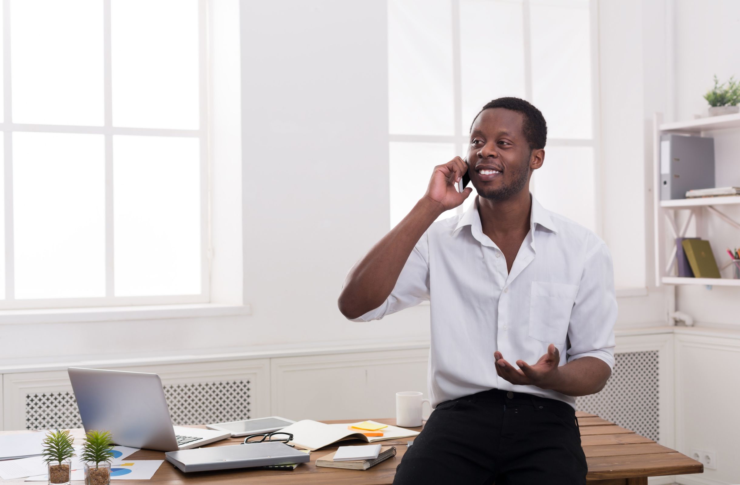 Business man talking on phone in an office